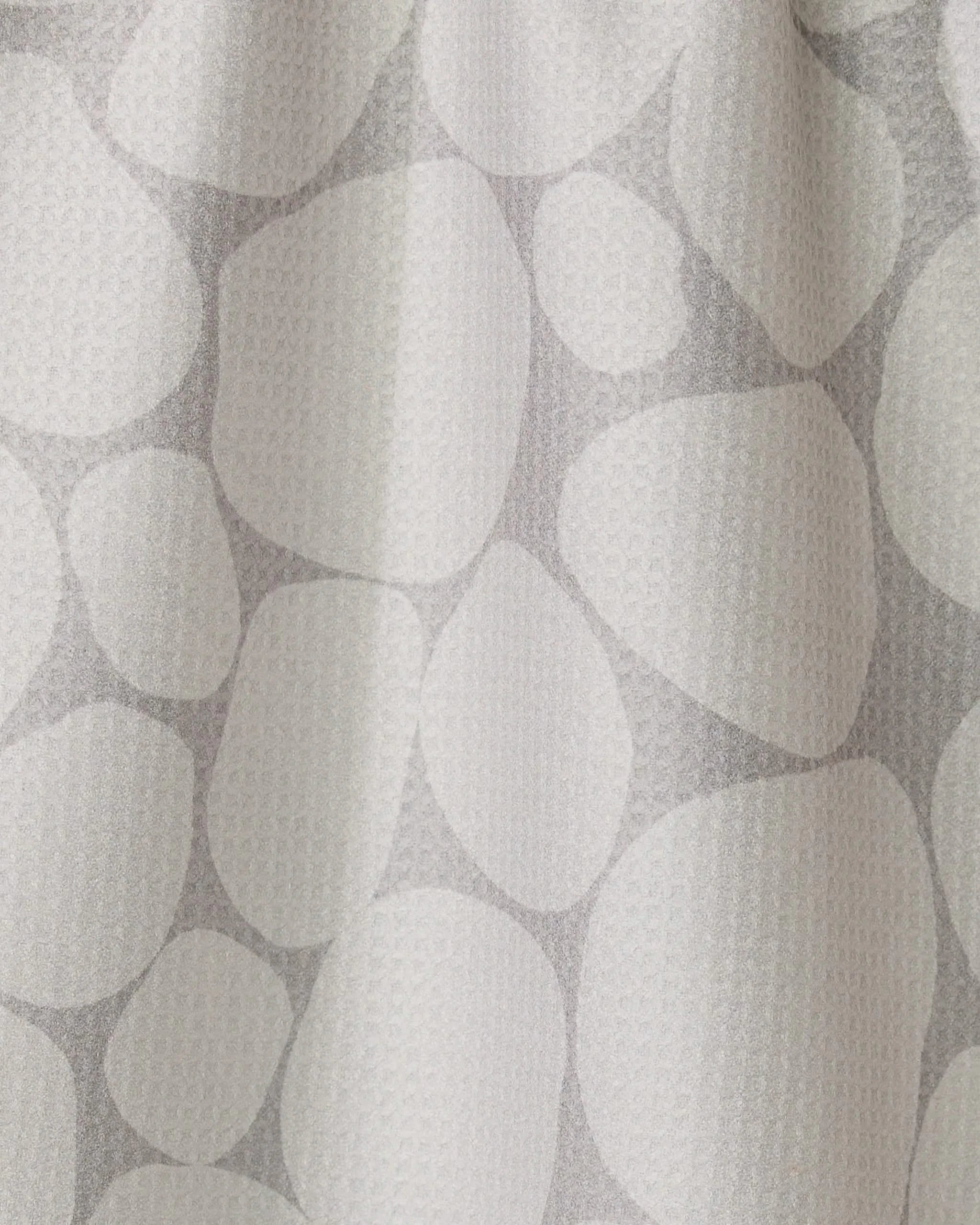 The Geometry Stone curtain is white with a subtle texture and features a light gray pattern of overlapping, irregular ovals and circles—resembling stones or pebbles, inspired by modern recycled kitchen towel designs.