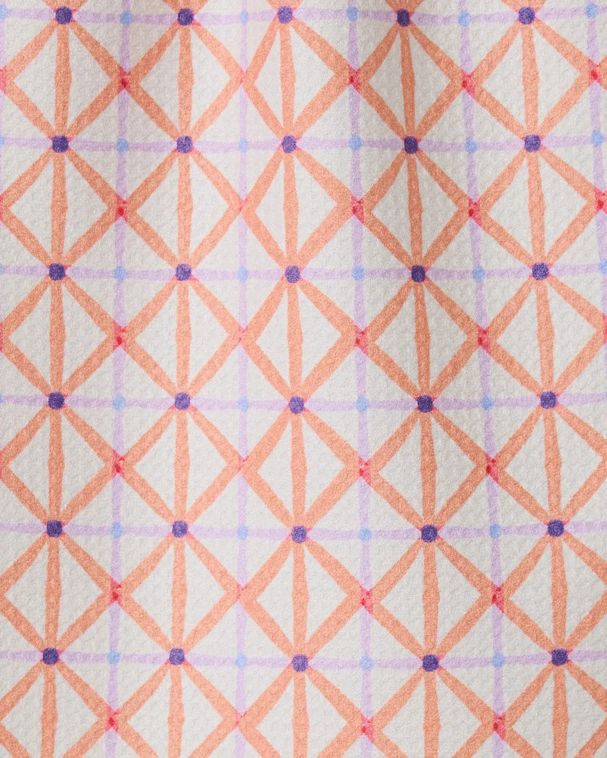 Anew by GEOMETRY is a patterned bar towel with intersecting orange and pink lines forming diamond shapes, accented by purple dots on a light background. Made from recycled materials for an eco-friendly touch.