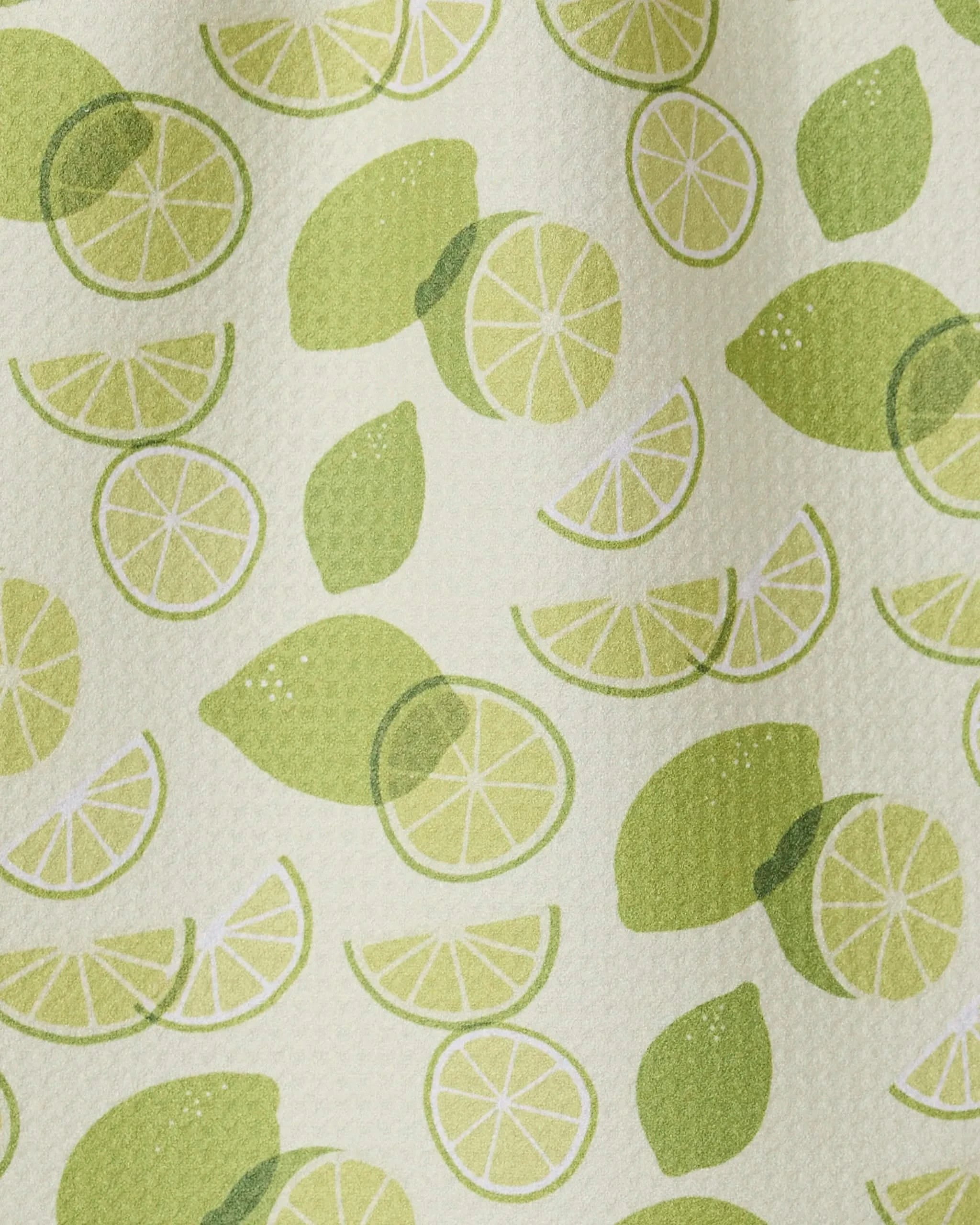 GEOMETRY’s “Limes” features whole limes, halves, and slices in green on a textured light background—ideal for an ultra-absorbent or recycled kitchen towel.