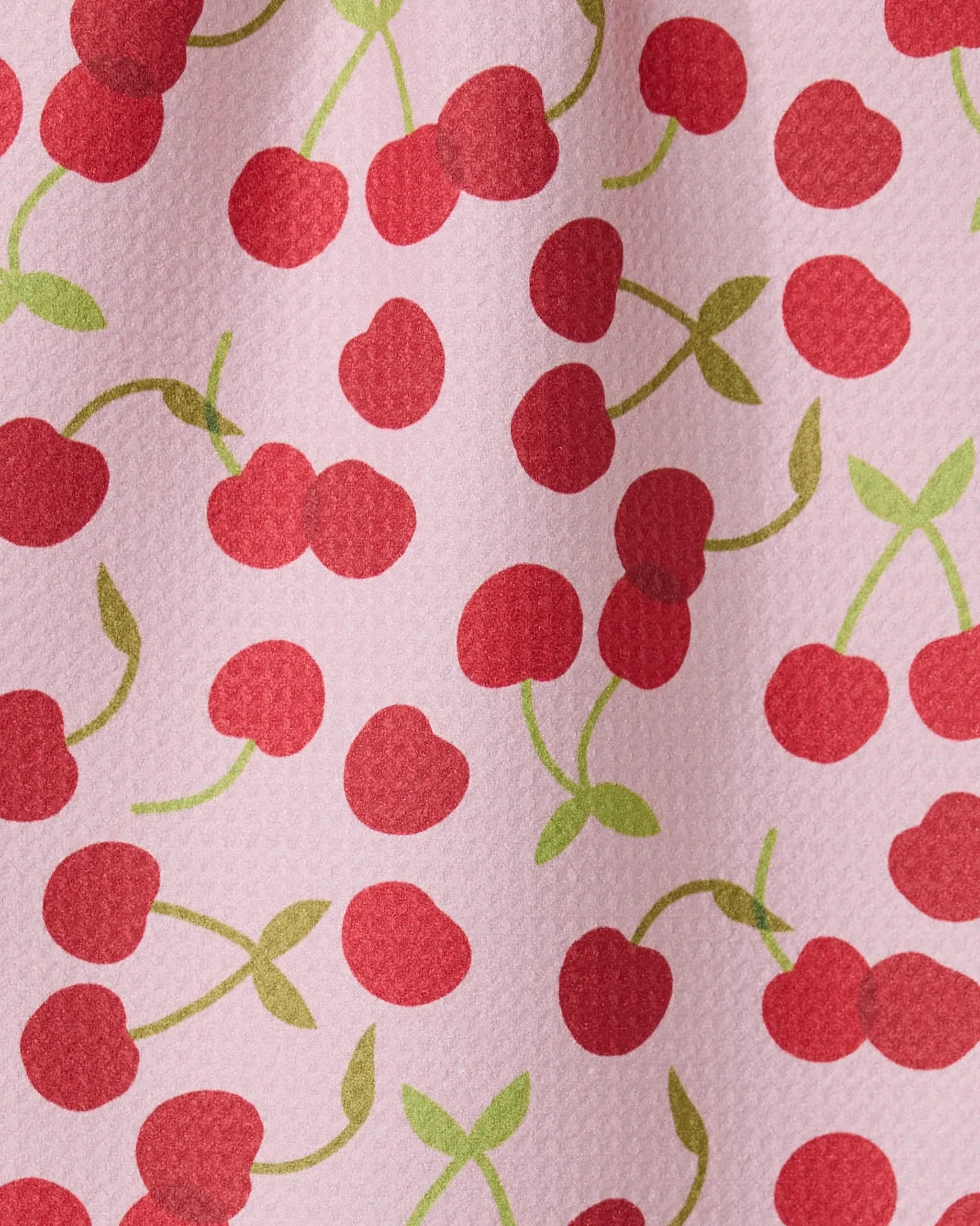 The GEOMETRY Cheery Cherries bar towel features a pink textured design with red cherries and green stems, made from recycled materials for an eco-friendly and ultra-absorbent option.