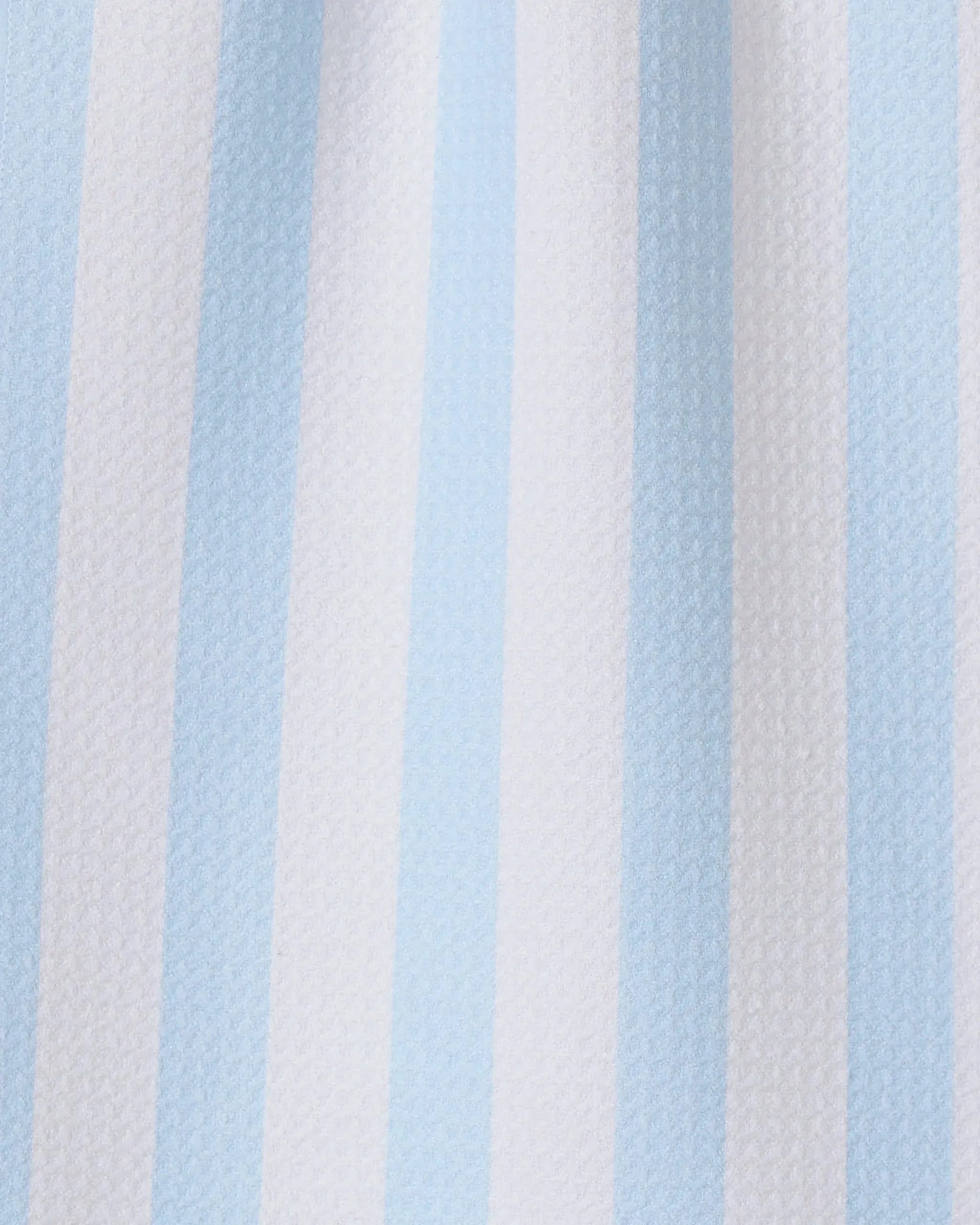 The GEOMETRY Seaside Stripes towel features vertical alternating pale blue and white stripes on textured fabric, making it a stylish and quick-drying choice for any kitchen.