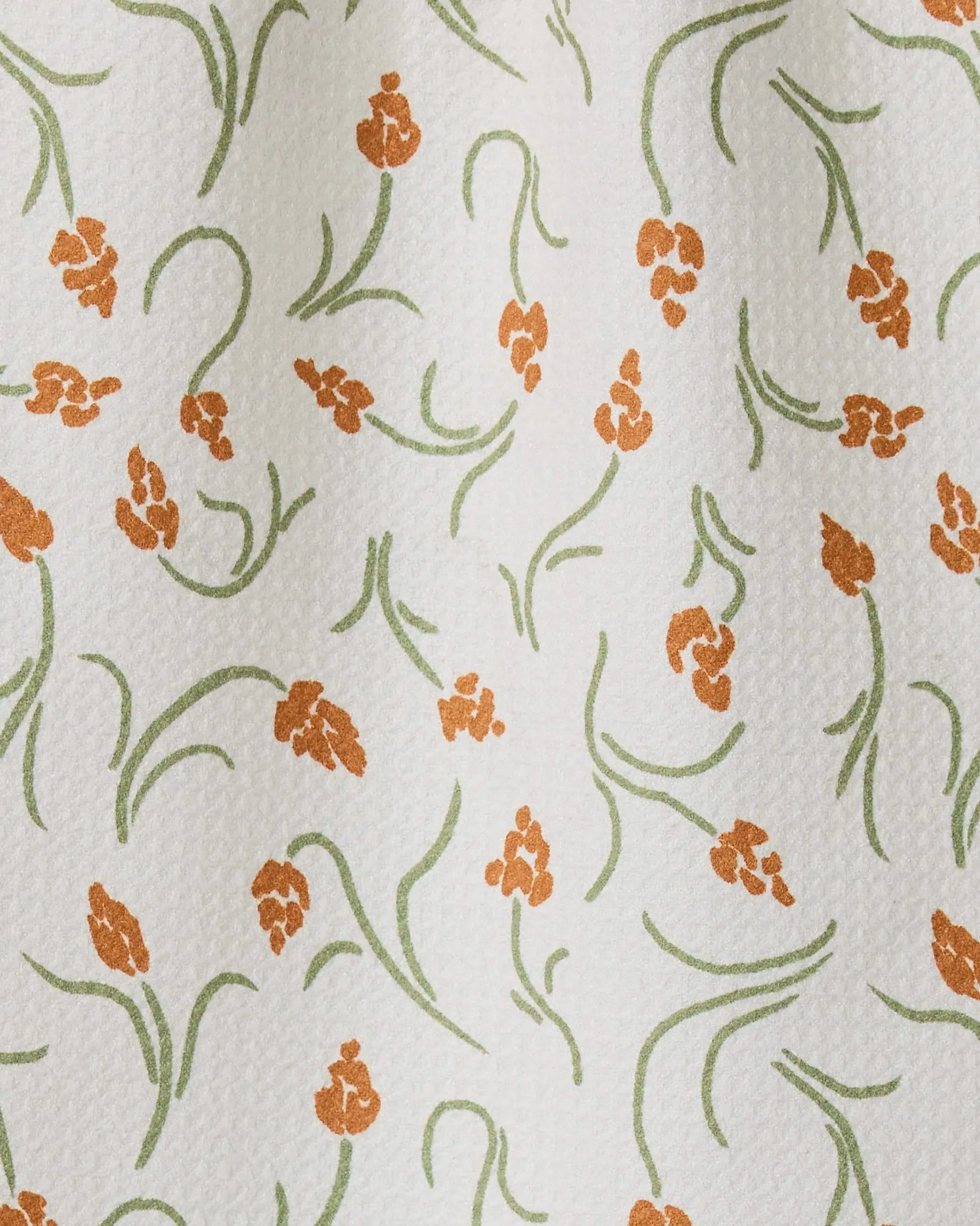 Crayon Floral by GEOMETRY: a white textured towel made from recycled materials, featuring small orange floral clusters with green stems and leaves—ultra-absorbent and perfect for kitchen or bar use.