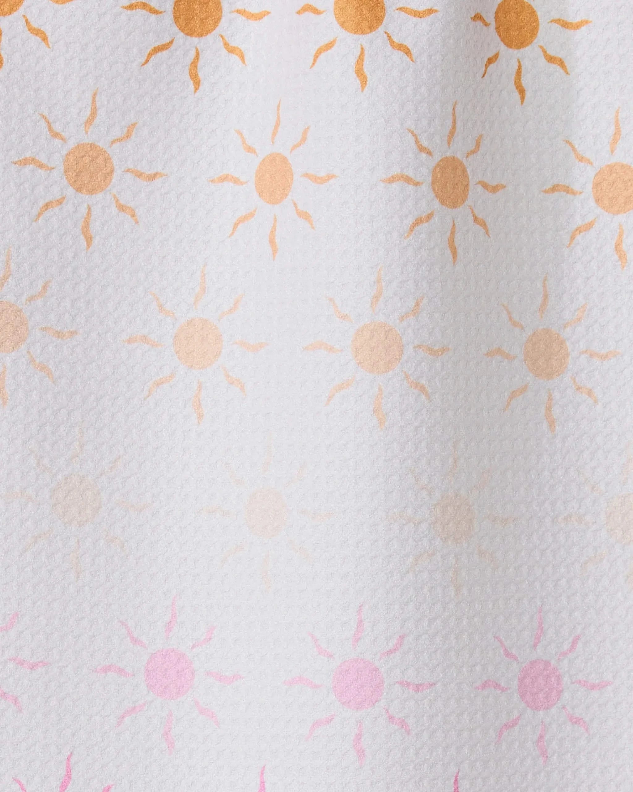 Fun in the Sun by GEOMETRY features rows of small sun patterns, orange fading to pink on textured white—ideal for inspiring an ultra-absorbent towel made from recycled materials.