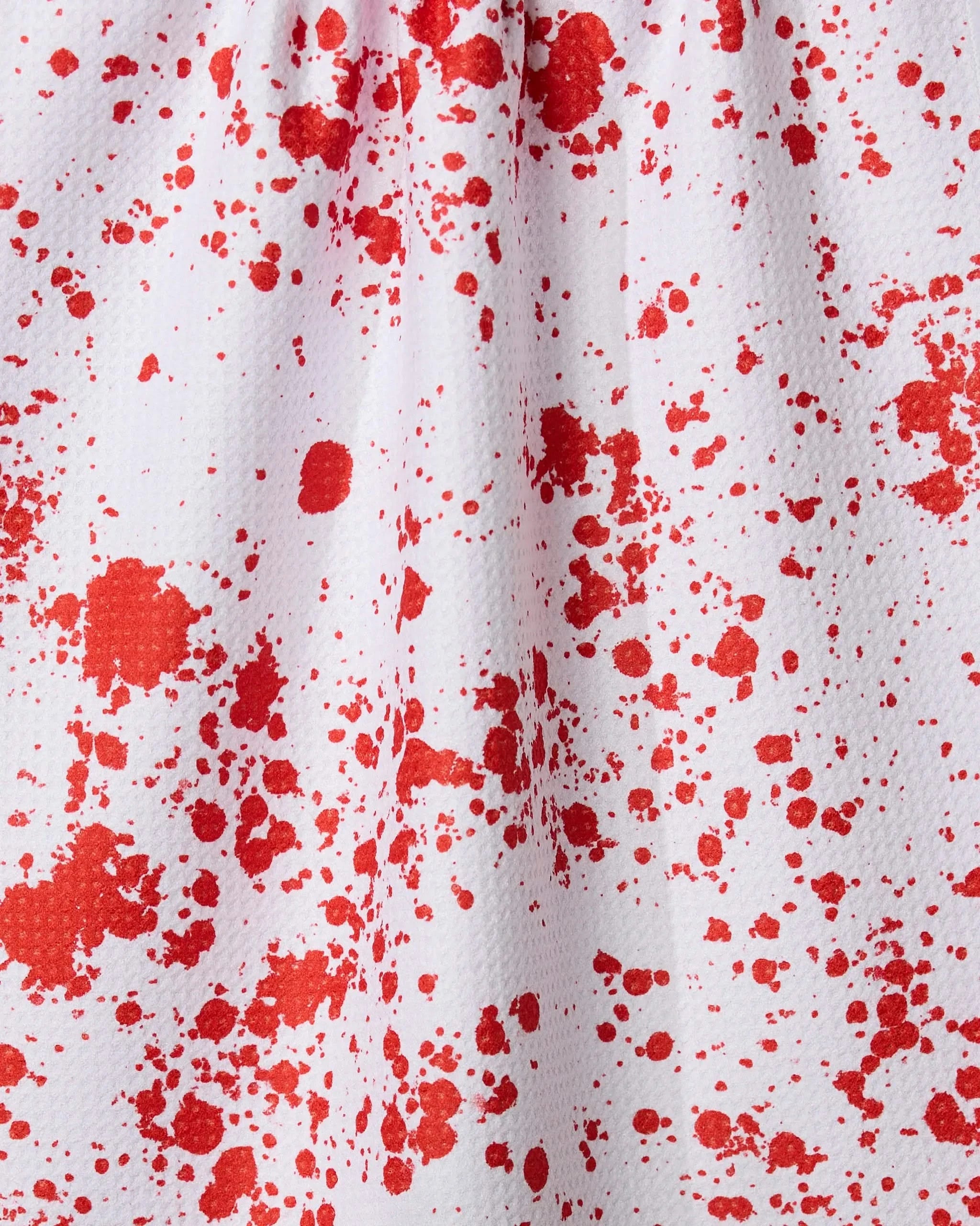 The Zombie Brains kitchen towel by Geometry features a white textured surface with uneven, scattered red splatters resembling paint or blood stains.