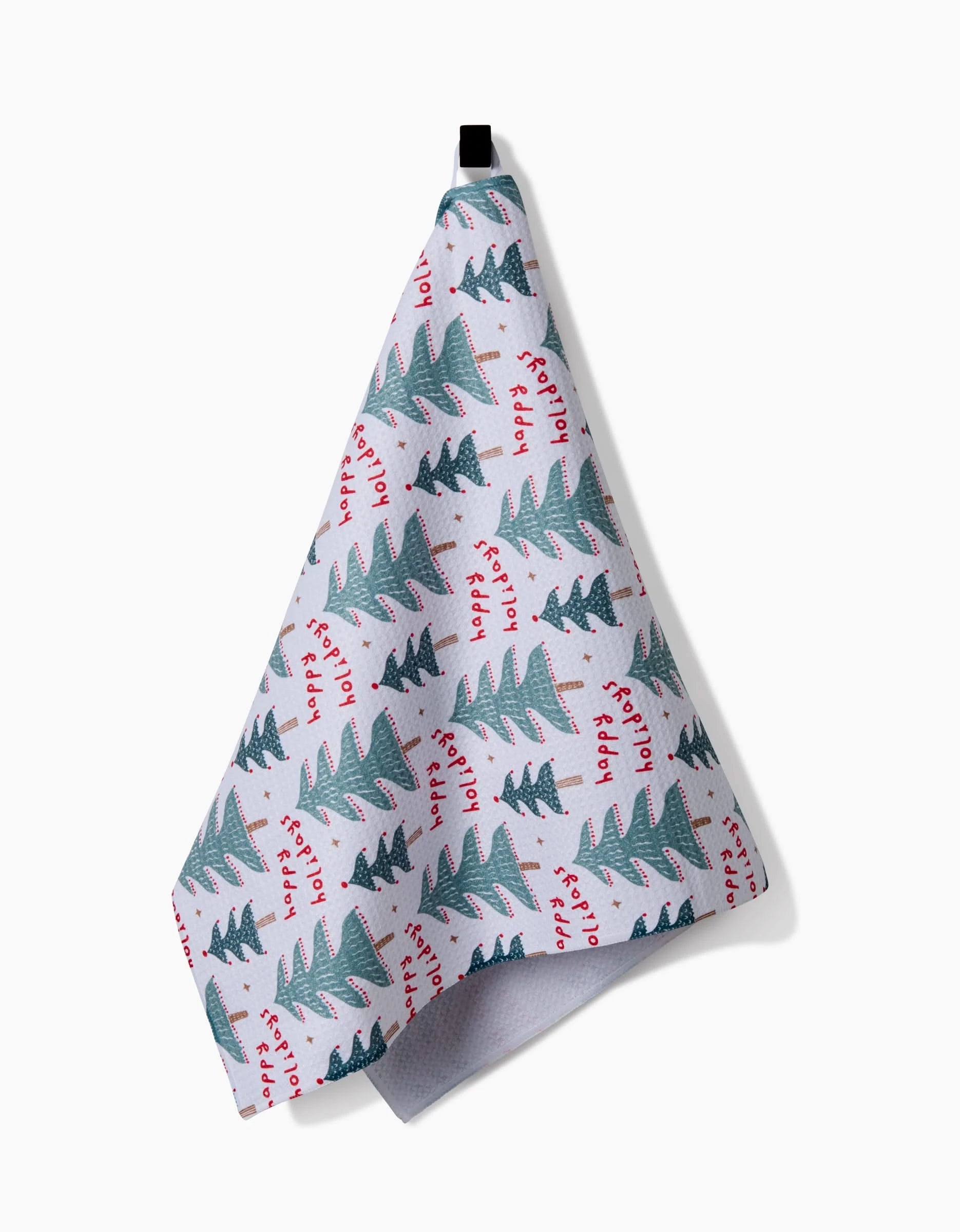 The Roxy Marj Berry Happy Holidays Luxe Hand Towel features green Christmas trees and red festive text, hangs by a black loop, and uses quick-drying Geoweave tech for style and superior performance.