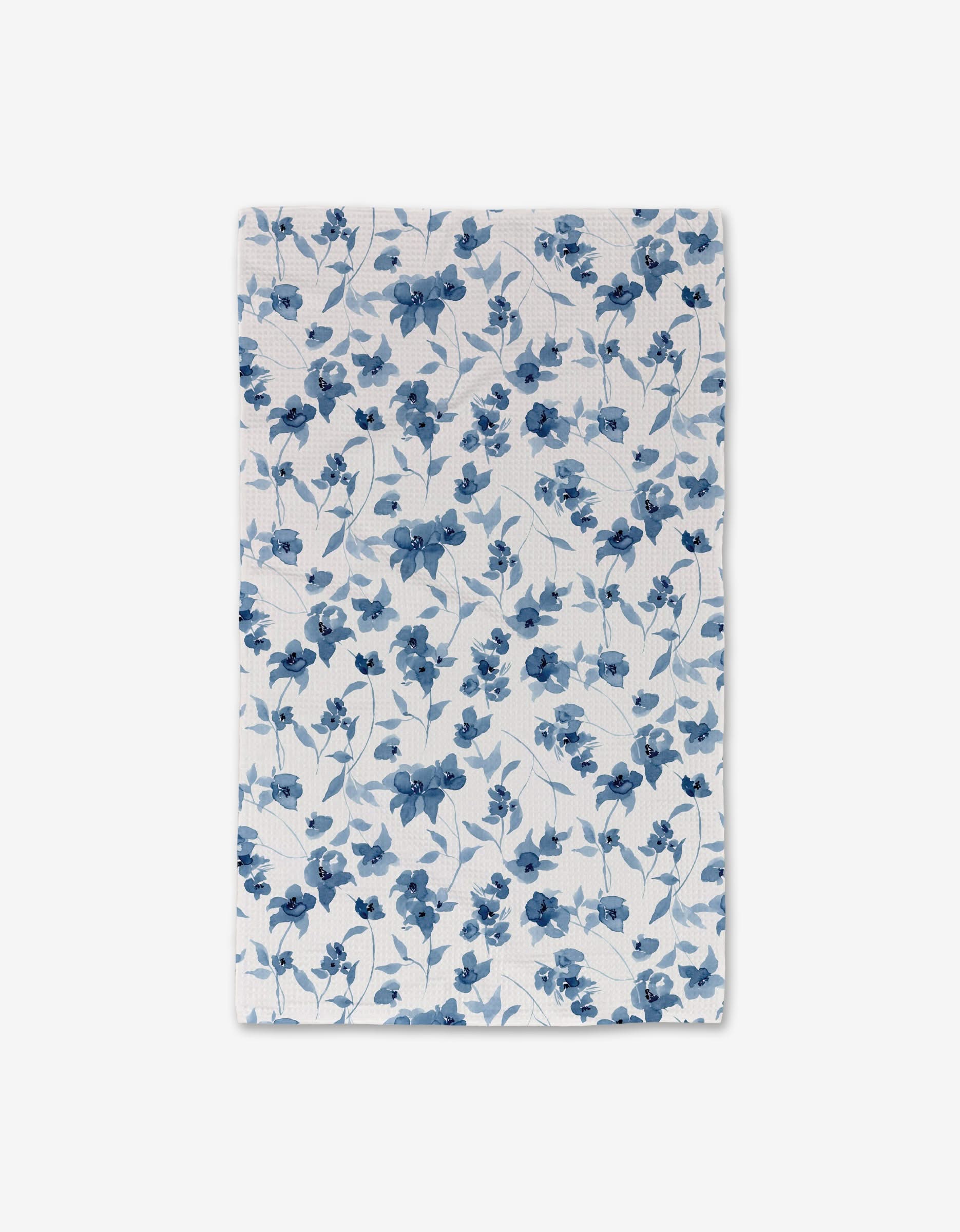 The Aubrey Fairchild Blue Floral hand towel features a white background with blue flowers and light blue leaves; its ultra-absorbent design ensures quick-drying comfort.