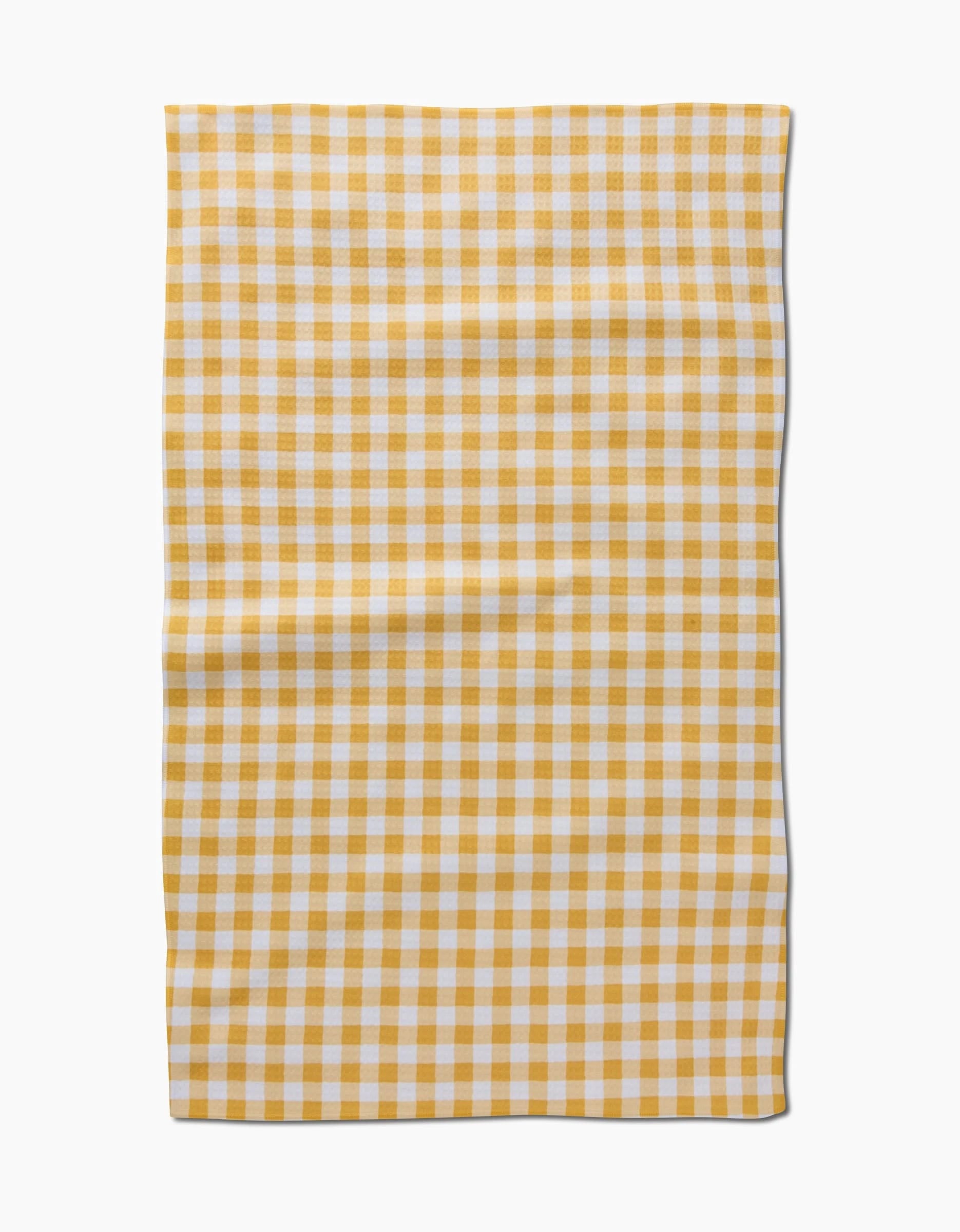 The Danelys Sidron Golden Plaid features a yellow and white checkered design, made from ultra-absorbent post-consumer recycled materials—style meets sustainability in this eco-friendly cloth.