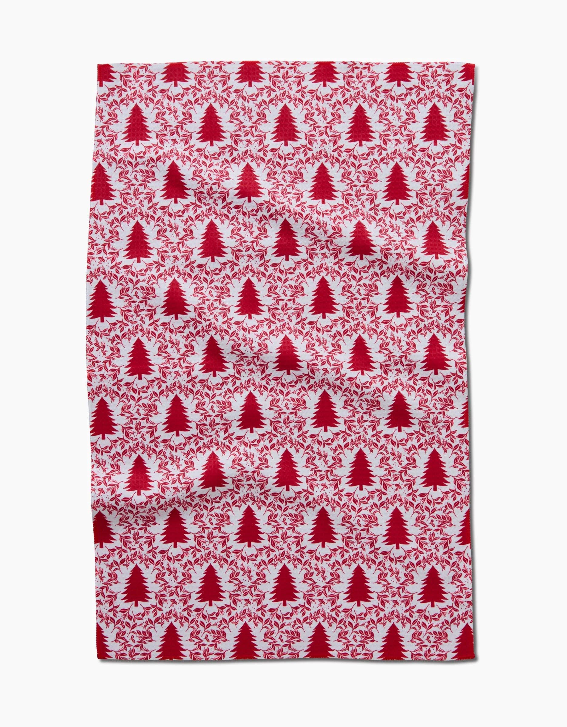 The Holiday Tree Luxe Hand Towel by Charlie Rowan Designs features a red Christmas tree and leaf pattern on white. Made with Geoweave technology, it offers a slightly wrinkled look and quick-drying convenience for daily use.