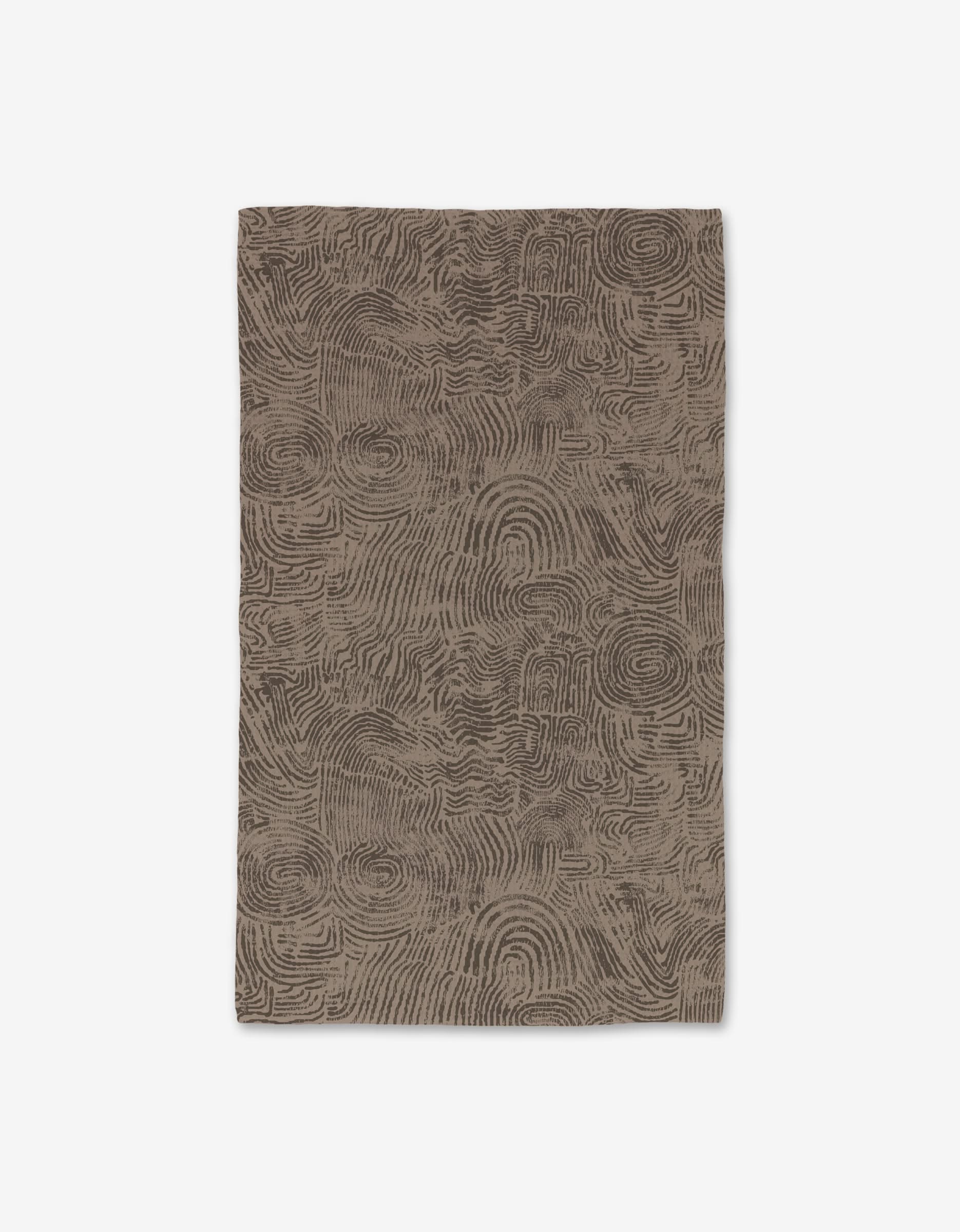The Imprint rug by Studio Jeannot is a rectangular brown mat with abstract swirling lines like topographic contours, crafted with Geoweave technology for ultra-absorbency, shown on a white background.