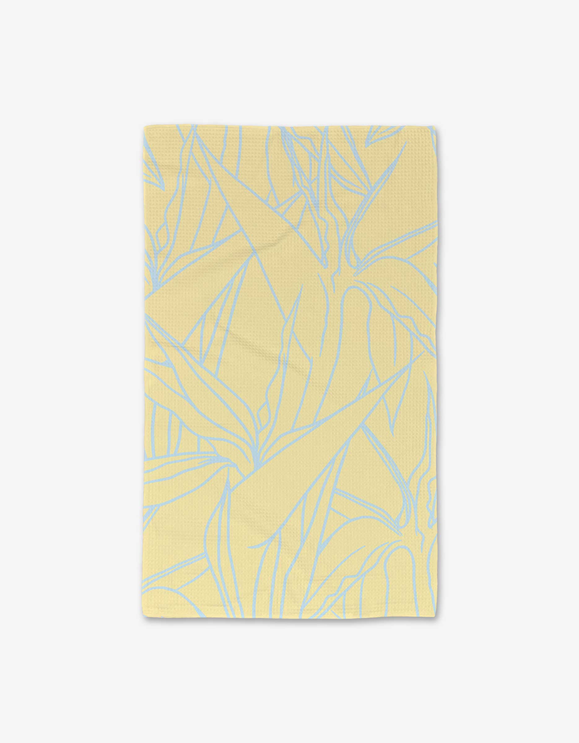 The GEOMETRY Paradise Blooms hand towel, in pale yellow and made from recycled materials, displays a subtle blue outline of overlapping leaves against a plain white background.