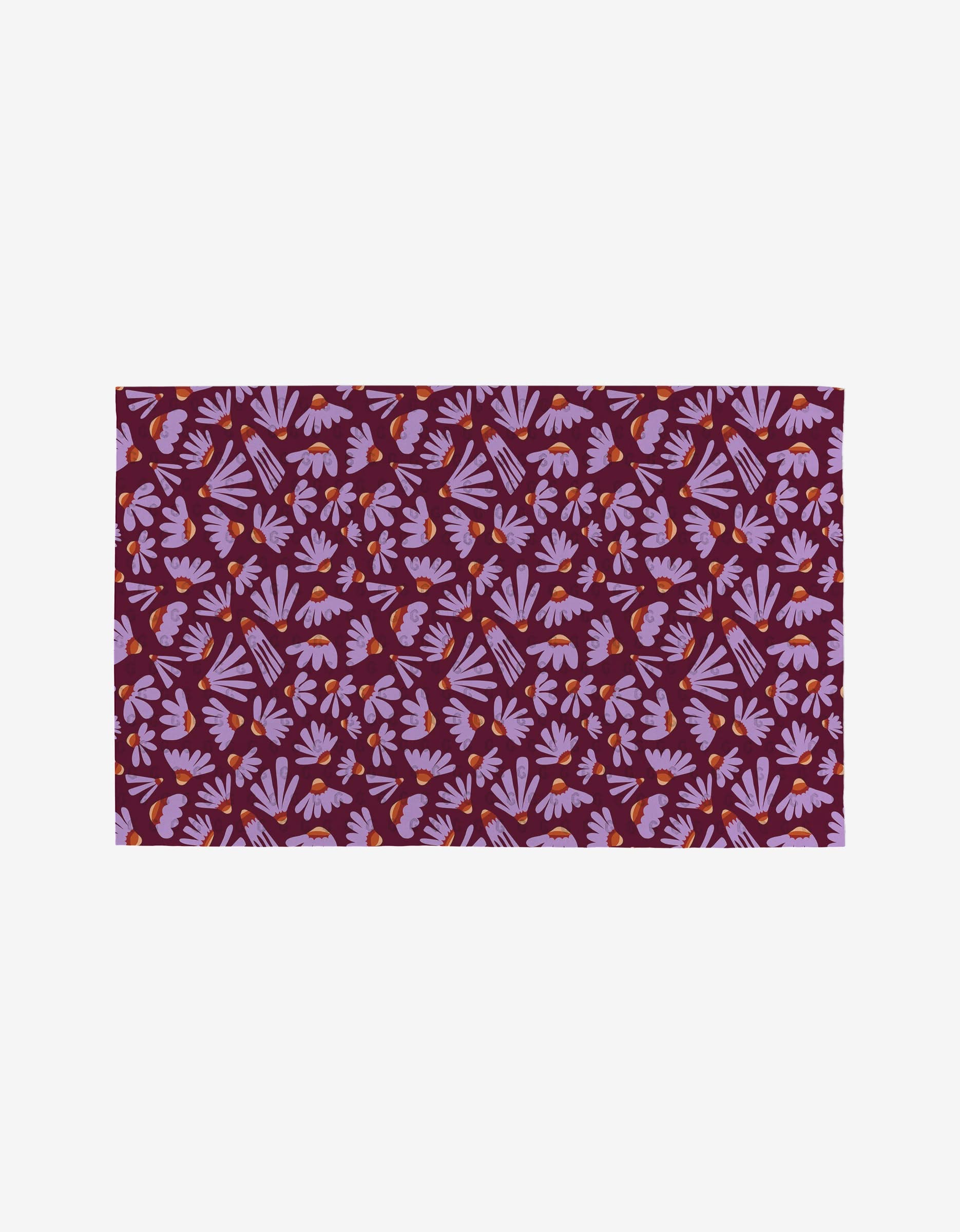 The Flower Pop rug by Elisabeth Wing has a maroon base with pink and purple leaf motifs and small orange accents, crafted from post-consumer recycled materials for an eco-friendly touch.