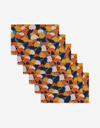 Five reusable rectangular placemats from Claire Iglesias, named Bold Petal Bloom, feature a repeating abstract scalloped pattern in orange, yellow, navy blue, and beige—an eco-friendly alternative to Not Paper Towels.