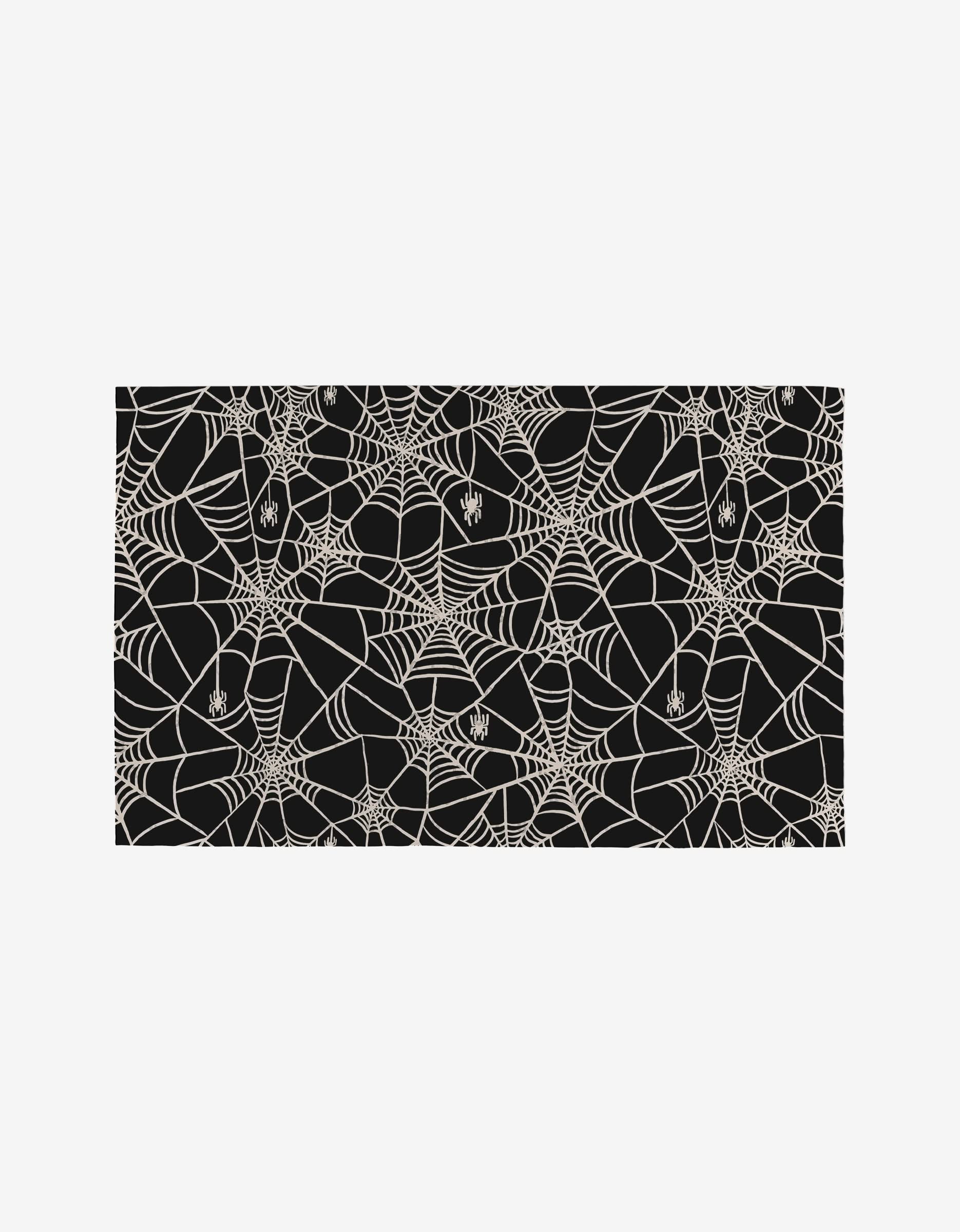 Kayla Ann’s Booos Not Paper Towels feature a black background with white spider webs and spiders, creating a spooky Halloween-themed design on an eco-friendly alternative to paper towels.