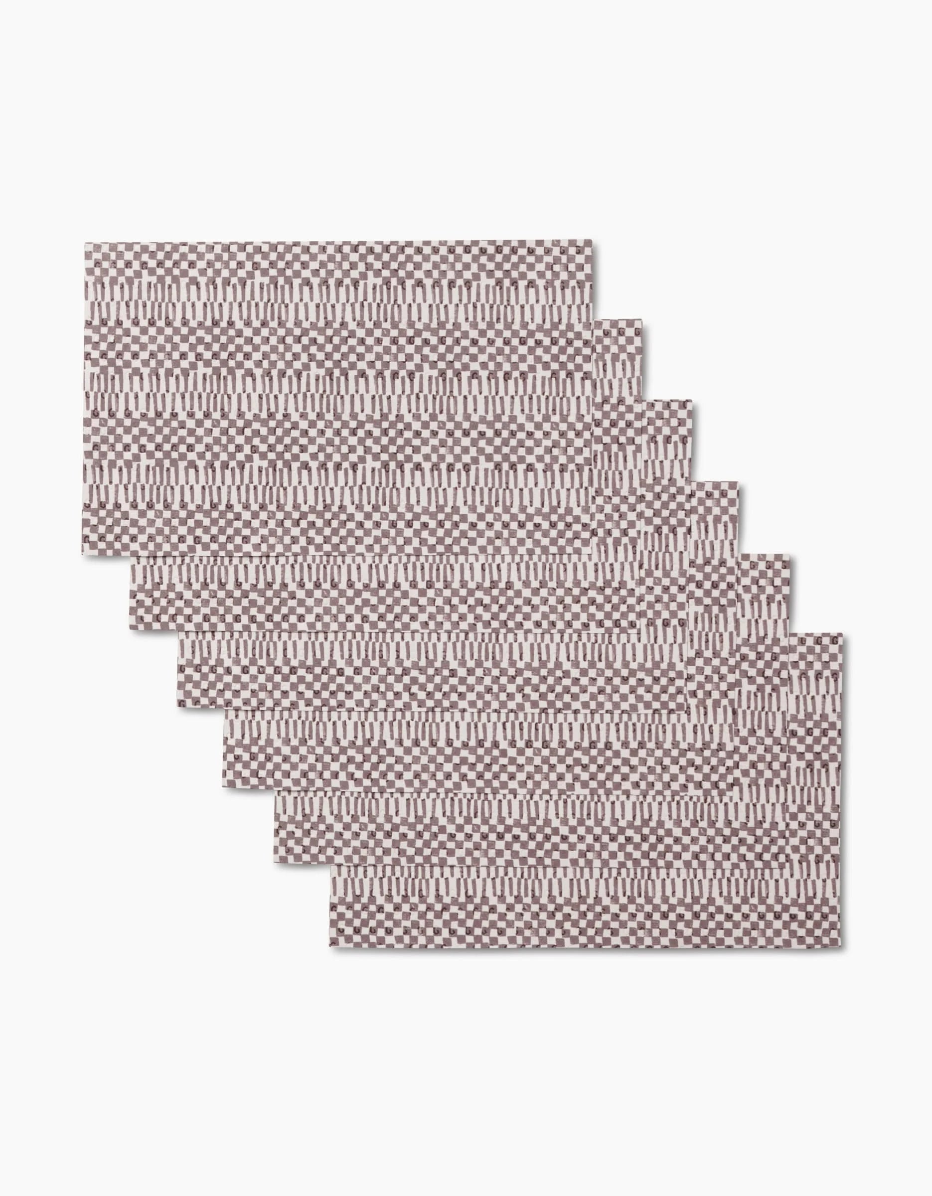 Six Chutes Coffee placemats by Studio Jeannot, featuring a brown and white geometric woven pattern made from recycled materials, are arranged in an overlapping stair-step layout on a white background.