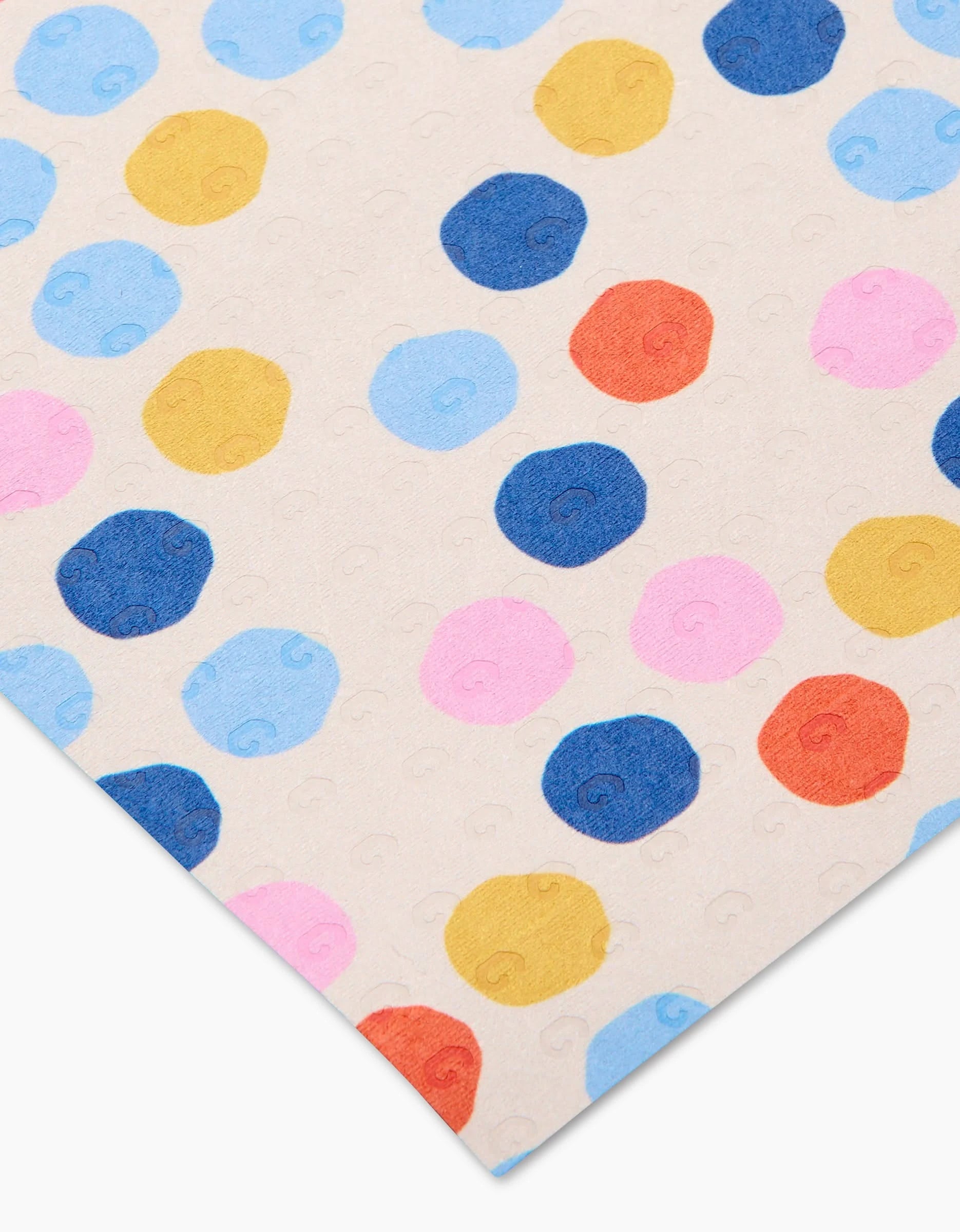 Carnival by Lizzie Clark is a reusable, eco-friendly sheet featuring colorful polka dots in blue, pink, yellow, and red on a light beige background. Not paper towels; image shows part of the sheet at an angle.