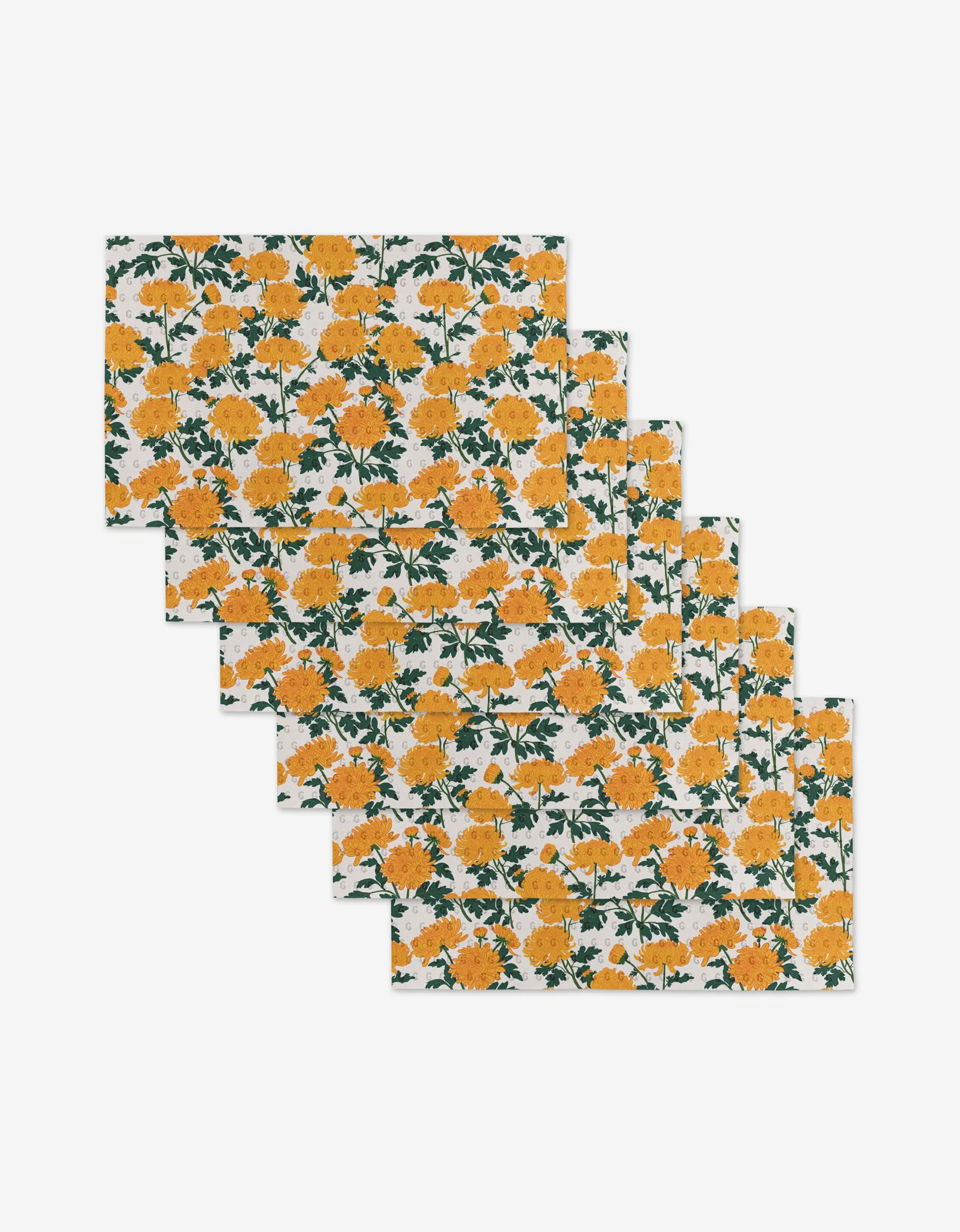 Set of six rectangular Chrysanthemum placemats by Vaishali Design Studio, featuring yellow and orange flowers with green leaves on a white background—an eco-friendly alternative to paper towels.