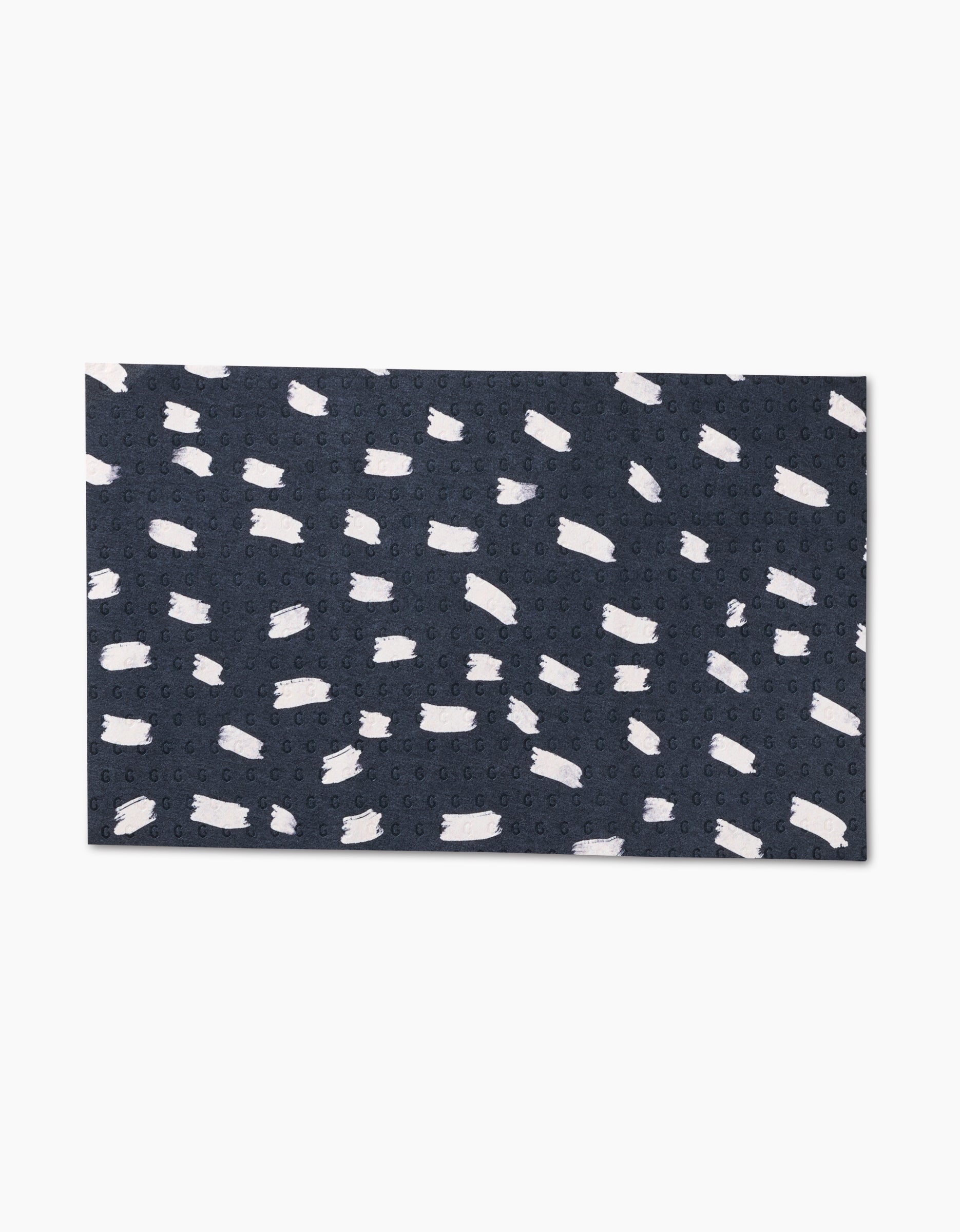 Dark Out by GEOMETRY: A rectangular dark blue fabric with small, irregular white brushstroke patterns, made from eco-friendly materials. Photographed on a plain white background.