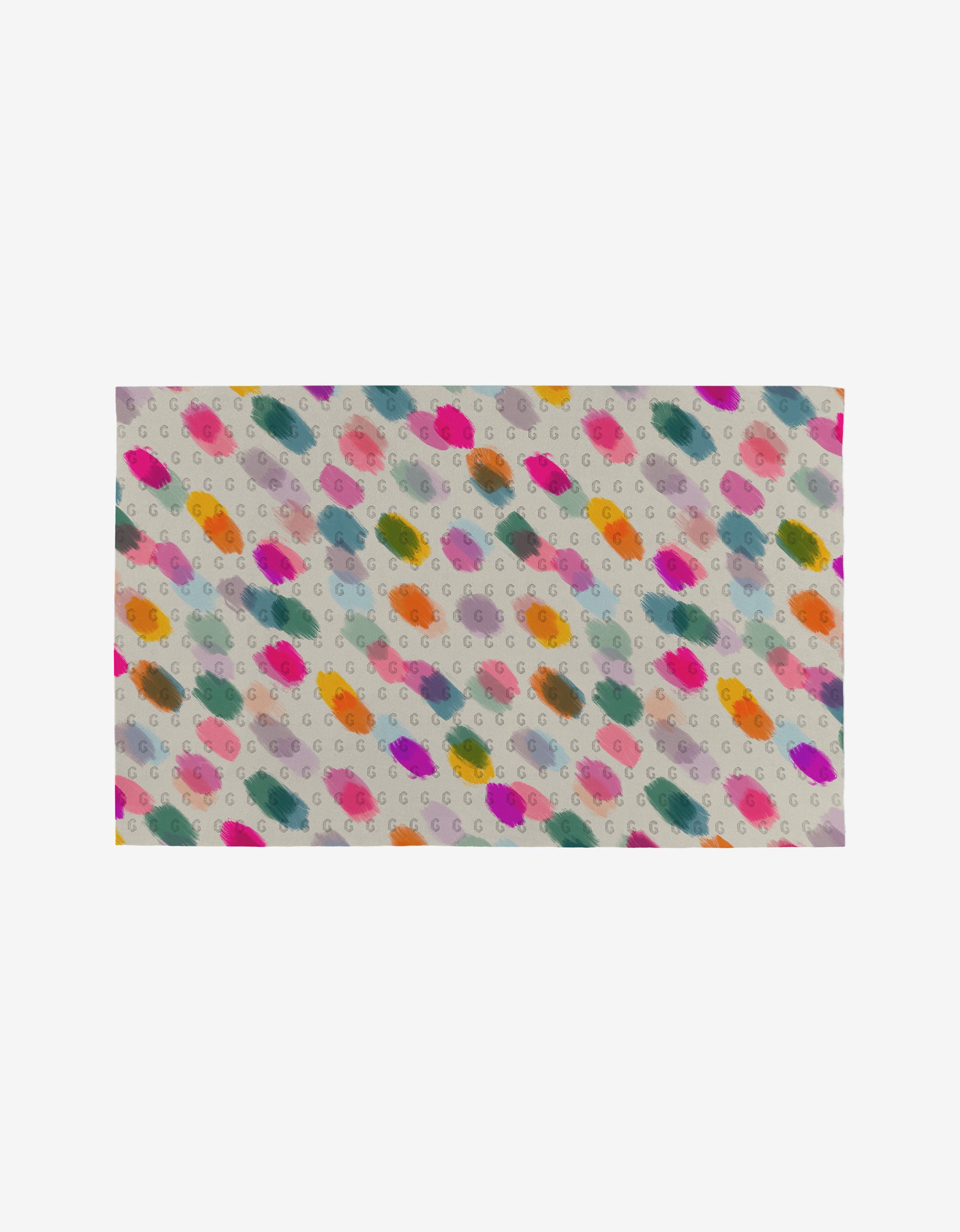 Downpour by GEOMETRY is a rectangular fabric featuring colorful paint-like splotches and small gray “G” letters on a light background, made from post-consumer recycled materials for an eco-friendly towel alternative.