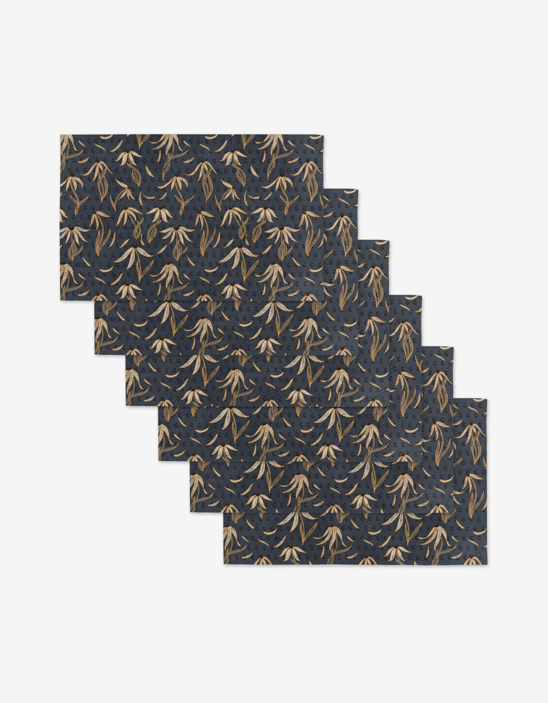 Six Echinacea mats by Katie OShea, made with eco-friendly materials, feature dark blue backgrounds and a repeating brown and tan leaf pattern. They are arranged in a staggered diagonal layout on a white surface.