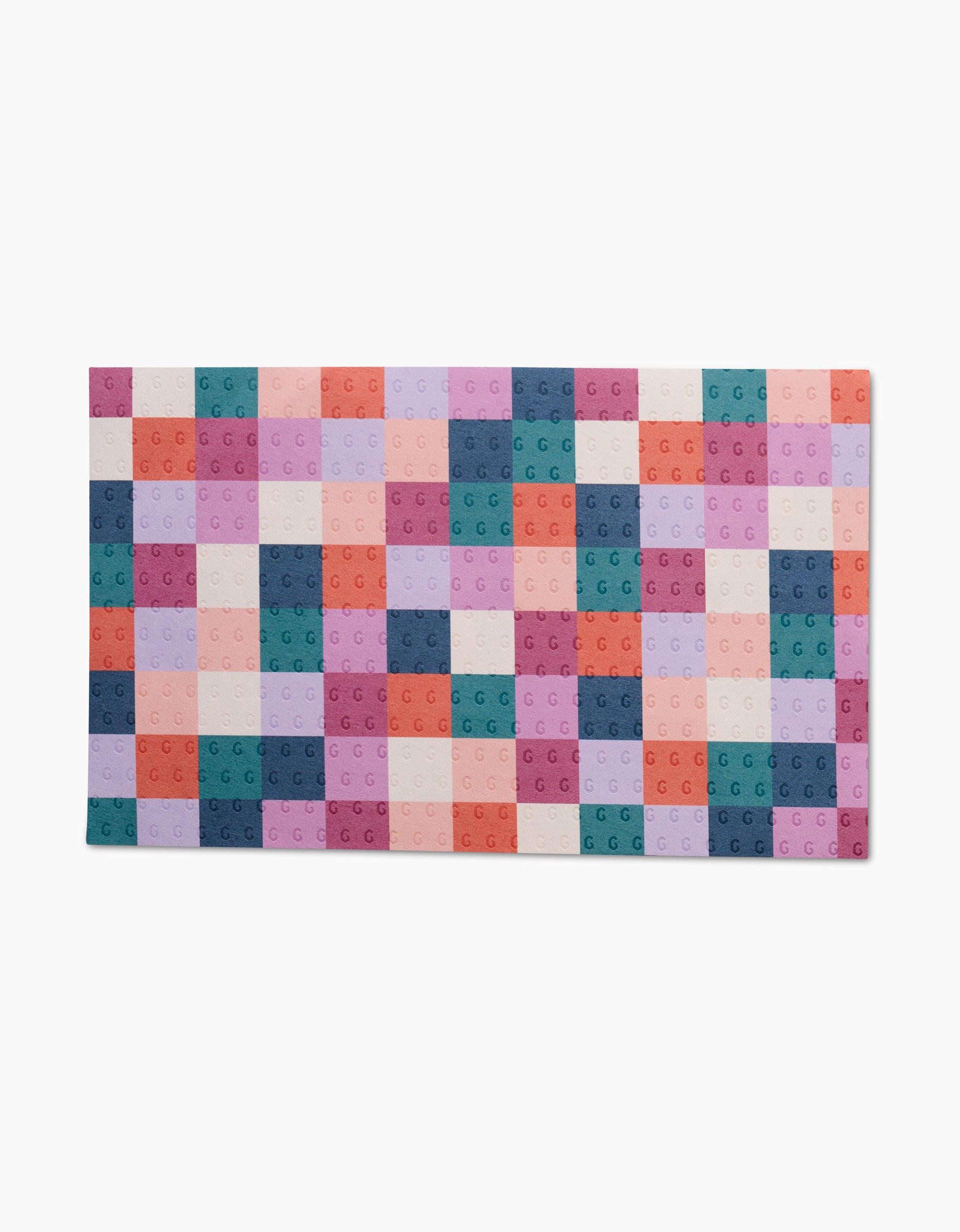 The Fall Checkers mat from Claire Iglesias is a reusable rectangular mat with a grid of pastel square tiles—pink, purple, teal, peach, and orange—each featuring subtle textured circles.