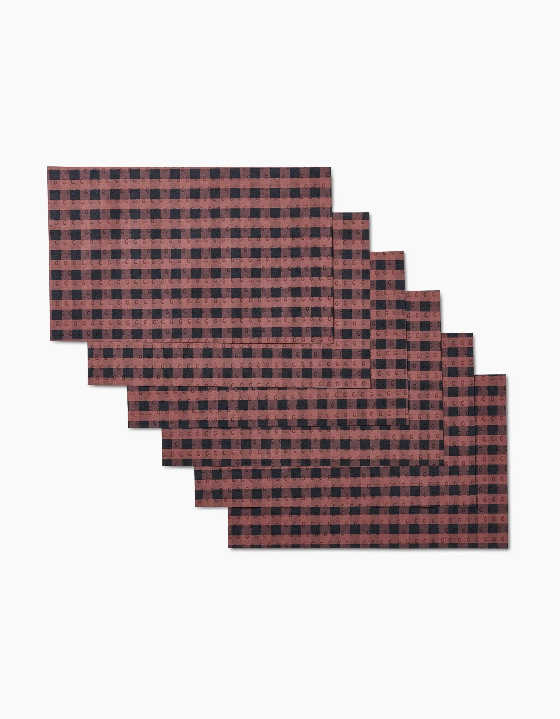 Six reusable rectangular GEOMETRY Fall Gingham placemats, featuring a red and black buffalo plaid design, are fanned out on a white background. Eco-friendly and ideal as Not Paper Towels for your table.