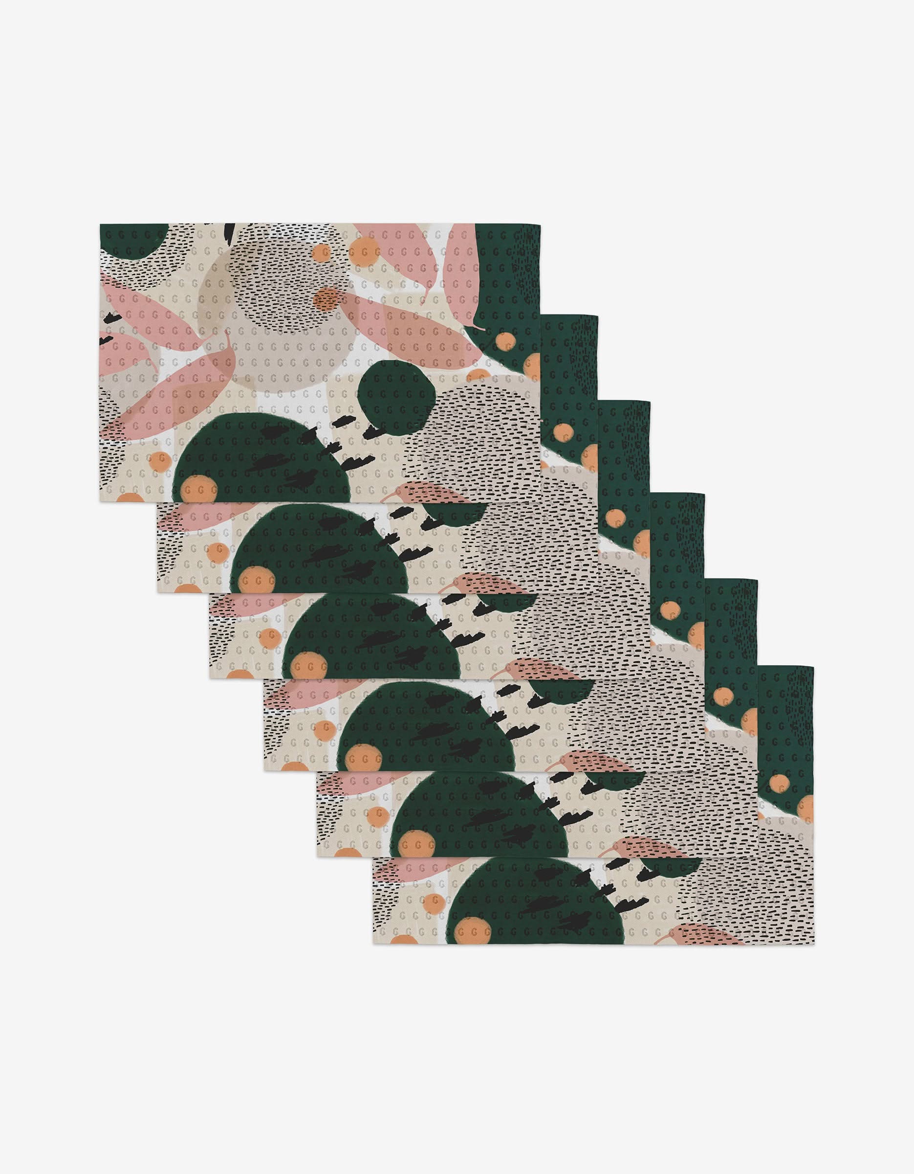 The GEOMETRY Falling set includes seven rectangular placemats made from recycled materials, each featuring abstract designs in green, pink, beige, and black on white, arranged in a staggered stack.