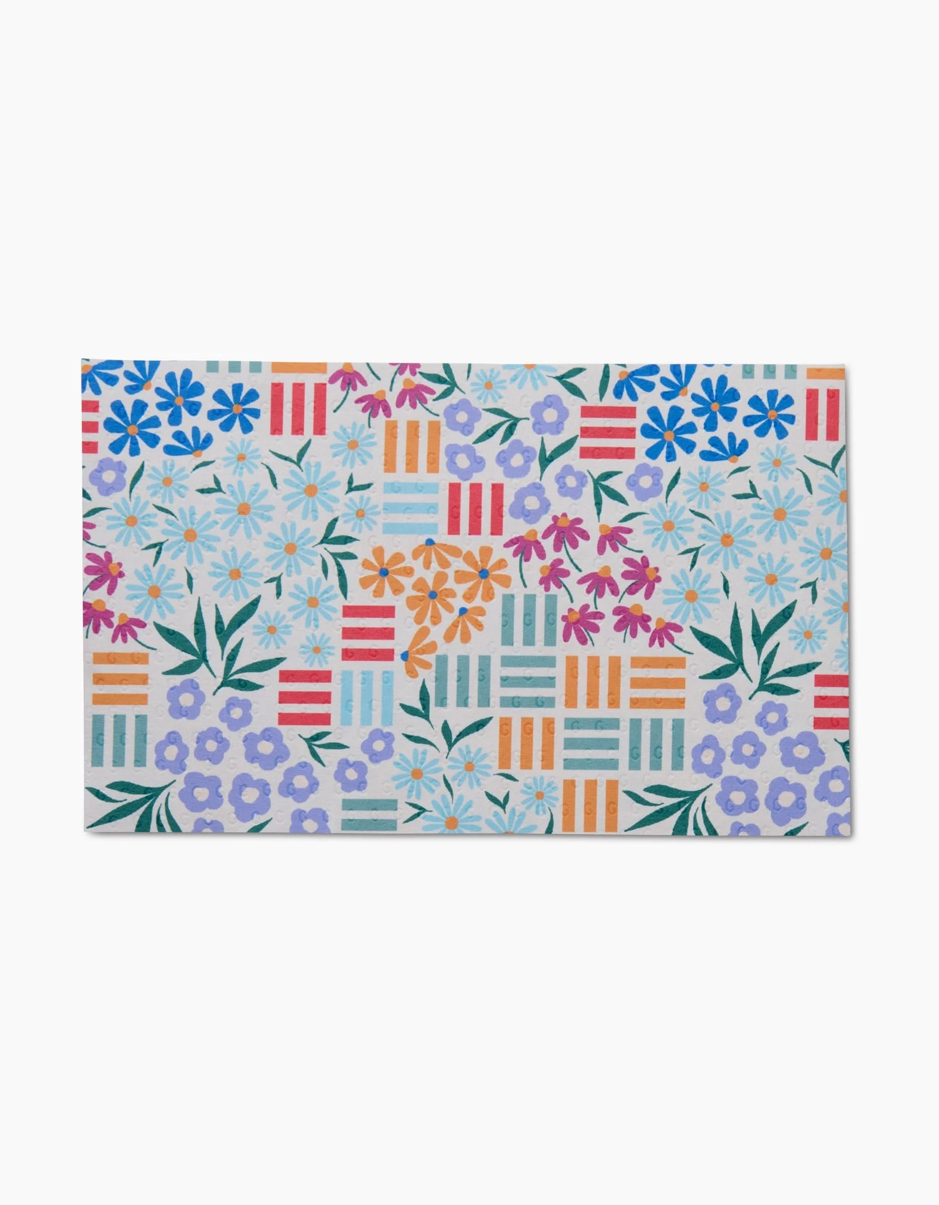 Floral Garden by Charlie Rowan Designs is a rectangular tile featuring colorful flowers, green leaves, and red, orange, and blue striped geometric blocks on a light background, made from post-consumer recycled materials.