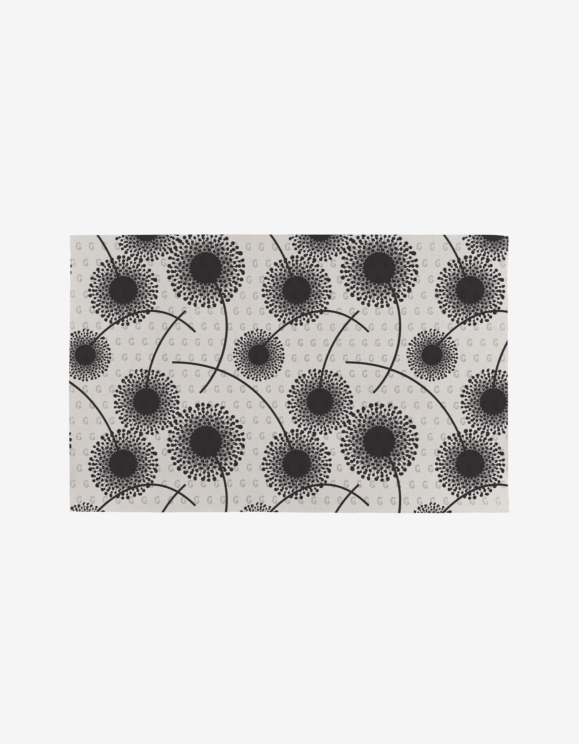 Fully Bloomed is a rectangular mat with a white background, showcasing a modern, abstract pattern of black dandelion flowers and dots—an eco-friendly, reusable alternative to Not Paper Towels.