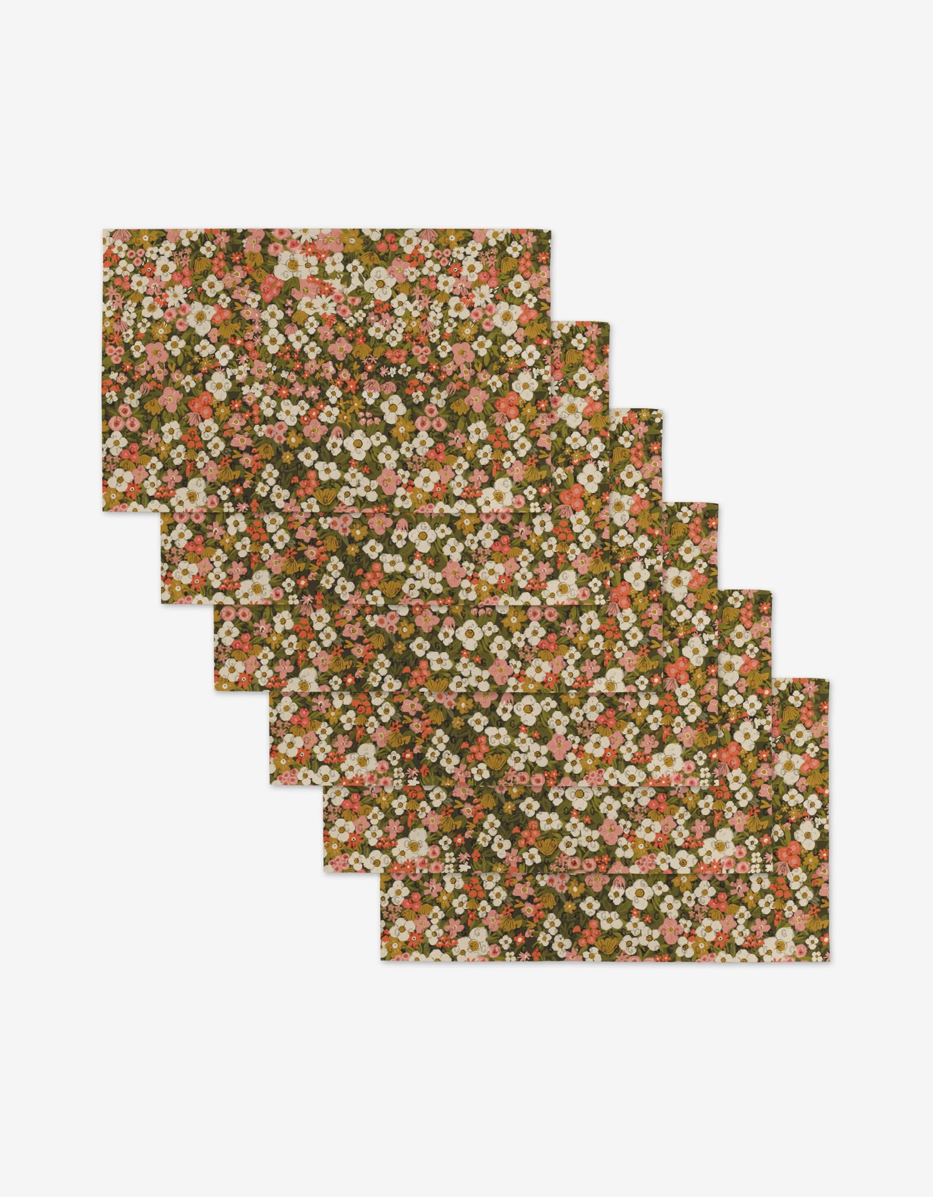 Six Gilded Garden rectangular, reusable placemats by Lisa Nelson—featuring pink, white, and orange flowers with green leaves on a brown background—are stacked on a white surface. An eco-friendly alternative to Not Paper Towels.