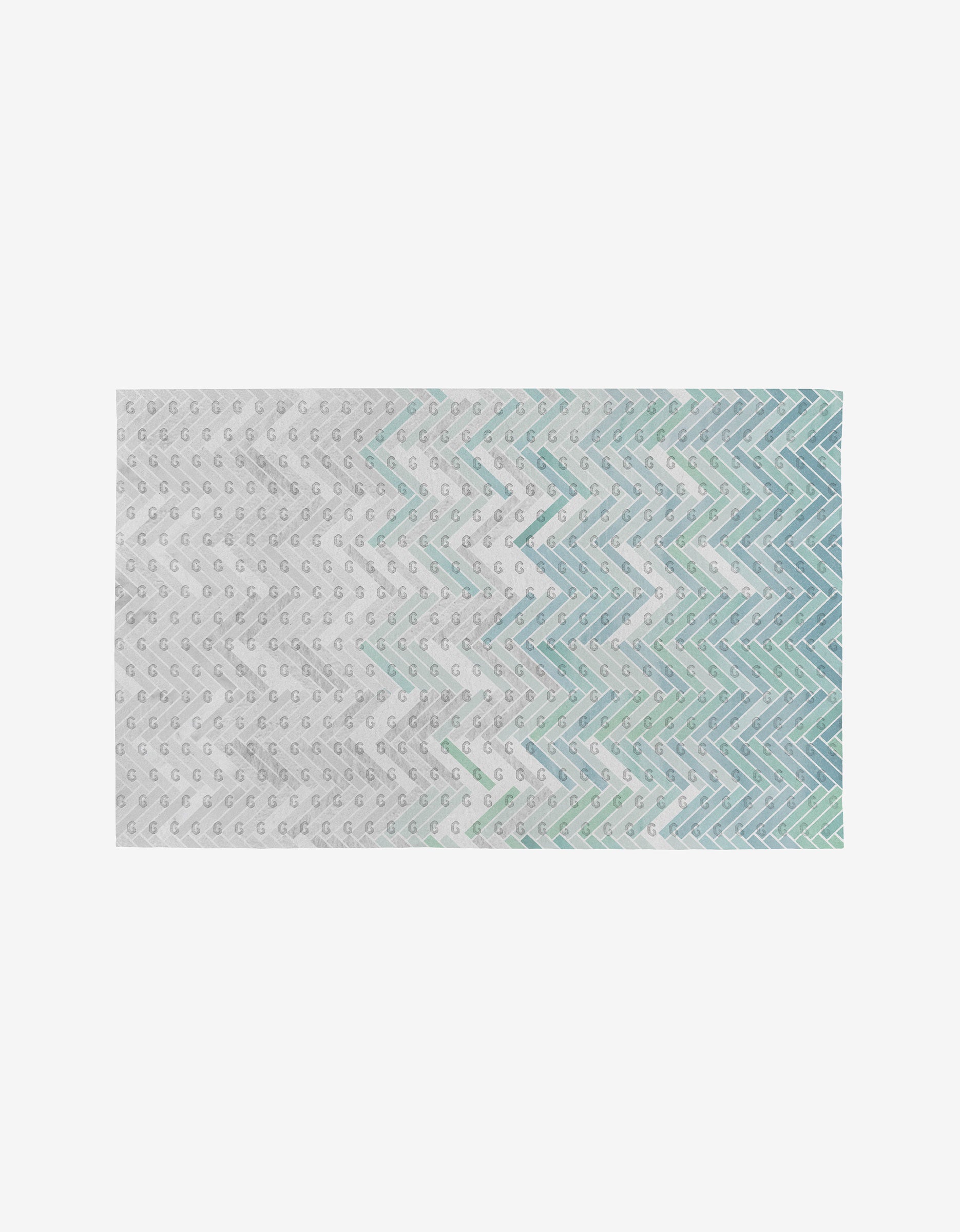 The GEOMETRY Going Up rug is a rectangular, eco-friendly piece with a white base and small gray dots, plus blue, teal, and mint green zigzag lines in a gradient. It’s reusable—unlike Not Paper Towels.