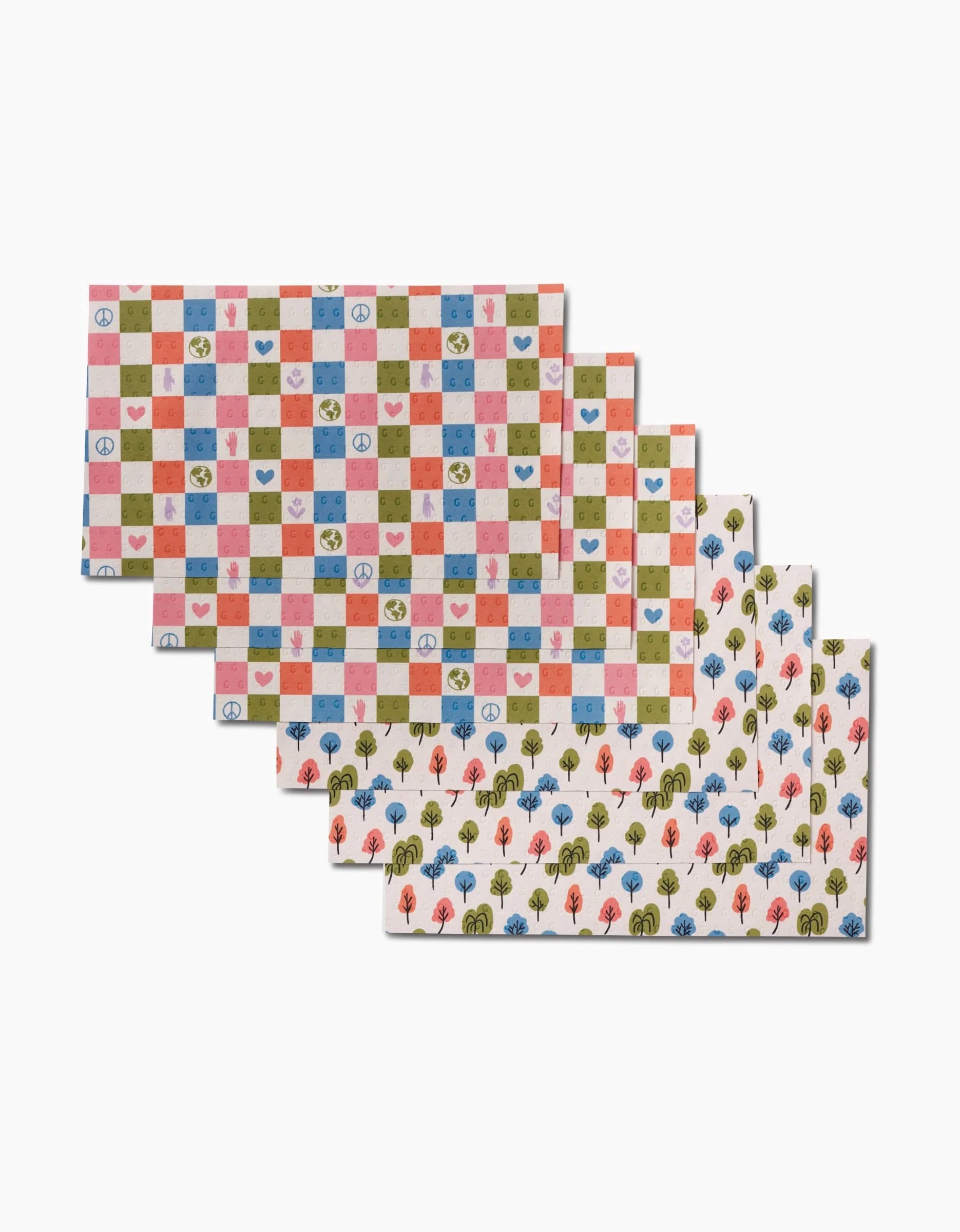 Five Happy Checkers sheets by Kayla Ann are stacked. Made from eco-friendly recycled materials, the top three show checkered hearts, clocks, and trees; the bottom two have vibrant trees on white. Not Paper Towels.