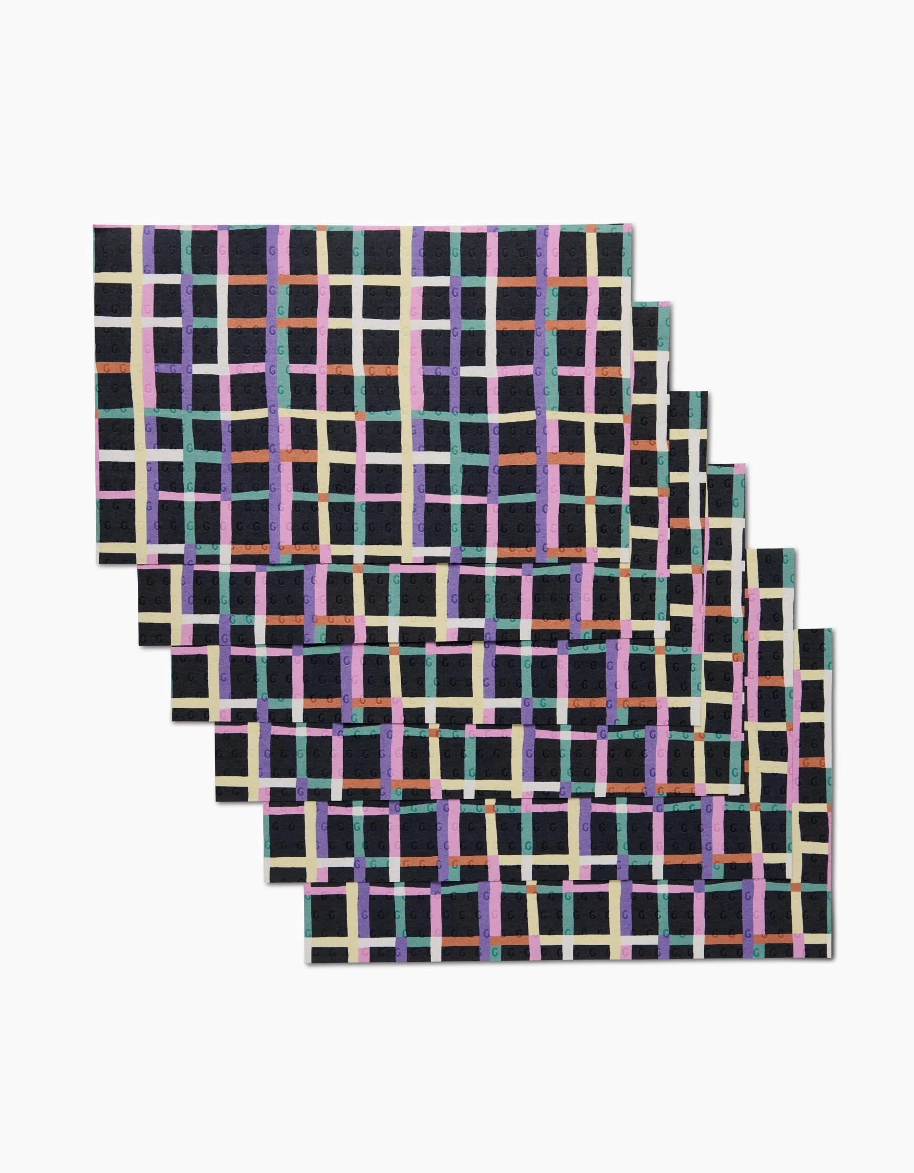 Claire Iglesias Happy Plaid: a set of five rectangular placemats made from post-consumer recycled materials, featuring a grid of purple, turquoise, cream, and pink lines on black—an eco-friendly alternative to Not Paper Towels.