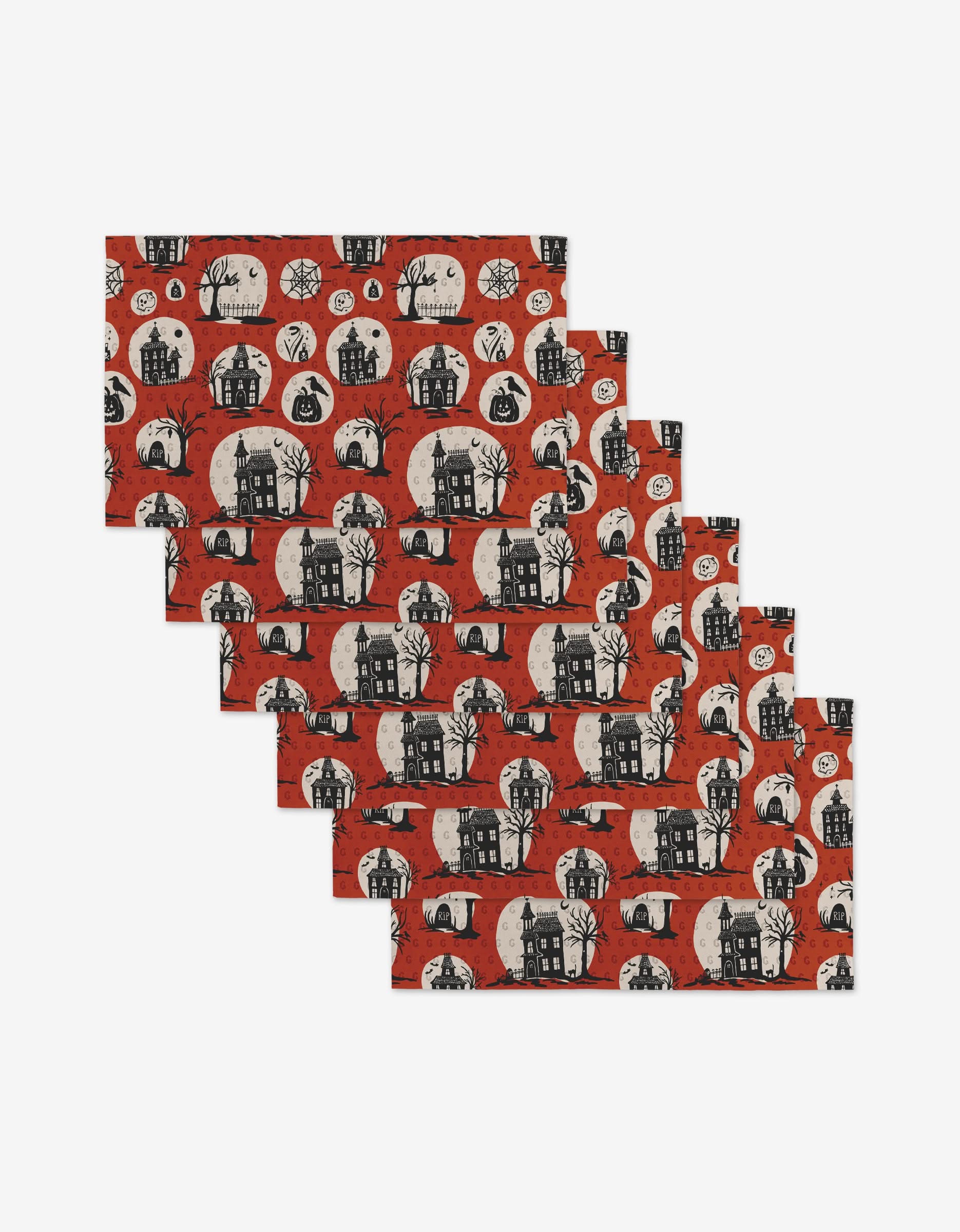 The Kayla Ann Haunted House set includes five reusable rectangular napkins, each with Halloween designs—haunted houses, black cats, bats, jack-o’-lanterns, and bare trees on red—an eco-friendly alternative to paper napkins.