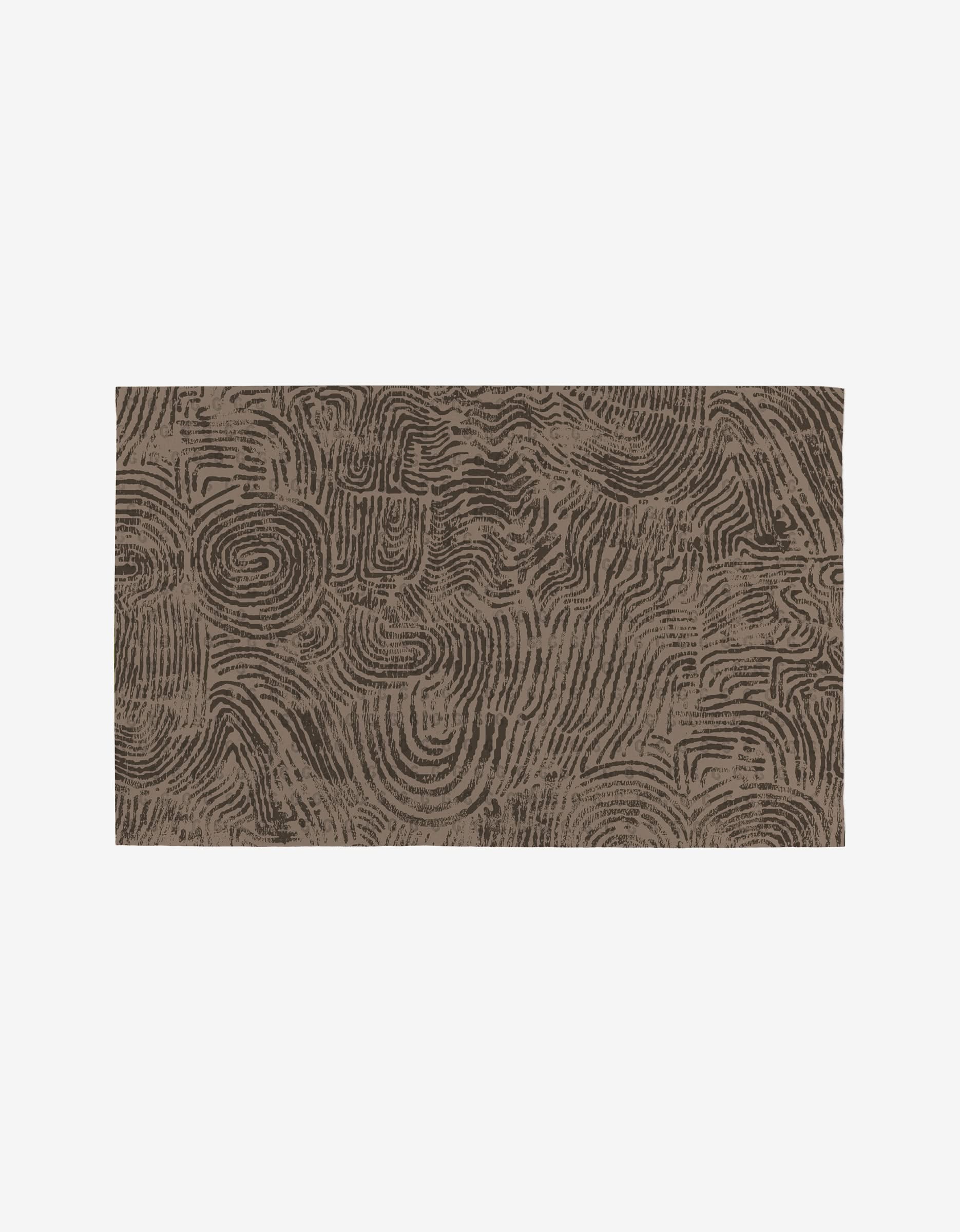 Studio Jeannots Imprint rug is a rectangular, brown design with abstract swirls and geometric shapes, echoing topographic contours—an eco-friendly, reusable décor alternative to disposables.