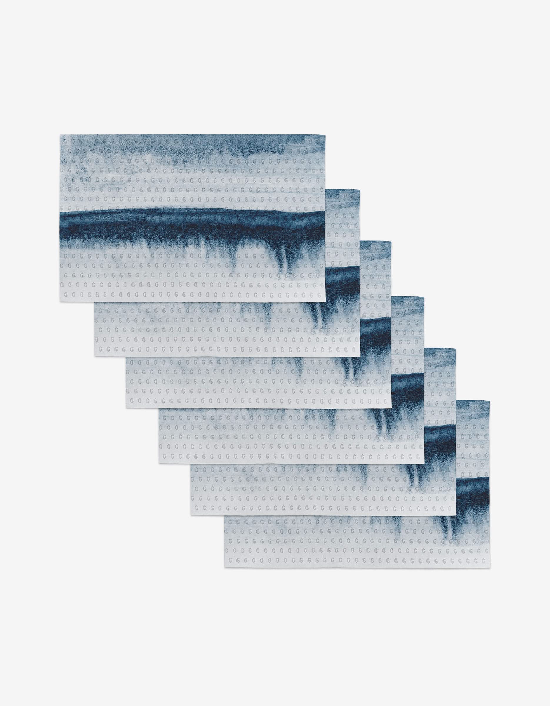 Six In The Distance rectangular placemats by GEOMETRY, featuring a blue and white watercolor stripe design arranged in a staggered formation—an eco-friendly, stylish dining alternative to disposable options.