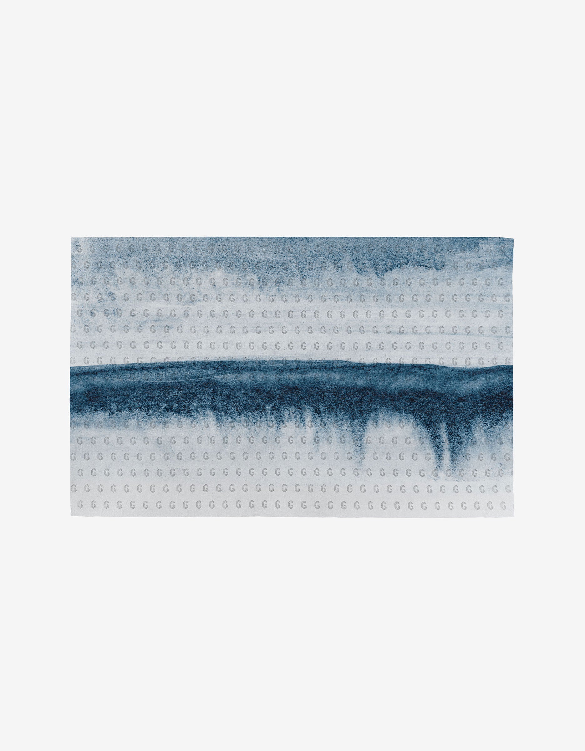 The GEOMETRY In The Distance towel features a rectangular shape, ultra-absorbent material, a white background with two blue watercolor streaks, and a subtle repeated G pattern—an eco-friendly alternative to disposables.