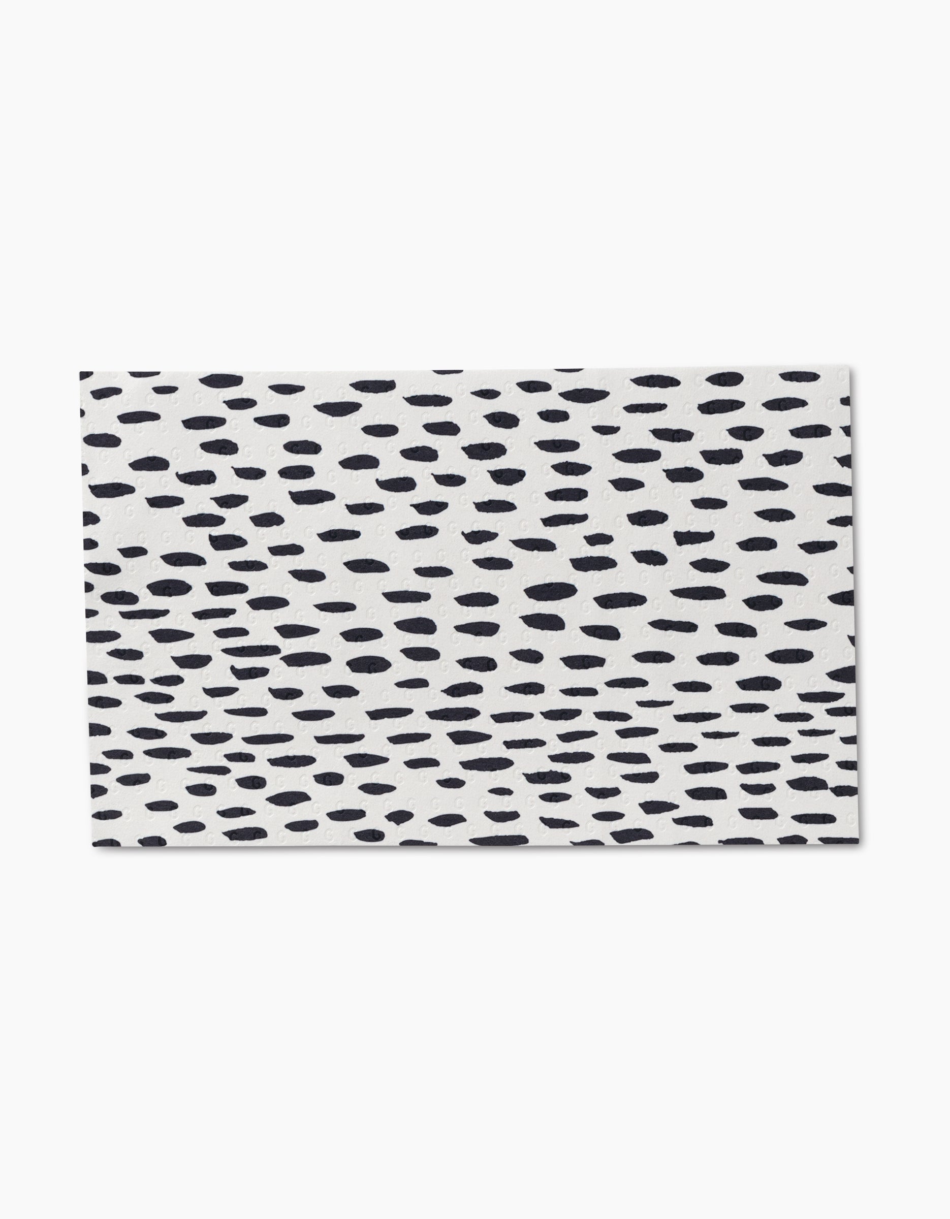 The GEOMETRY Lines, Dots and Dashes tile features a white background with an irregular pattern of small black oval dots, crafted from eco-friendly post-consumer recycled materials.