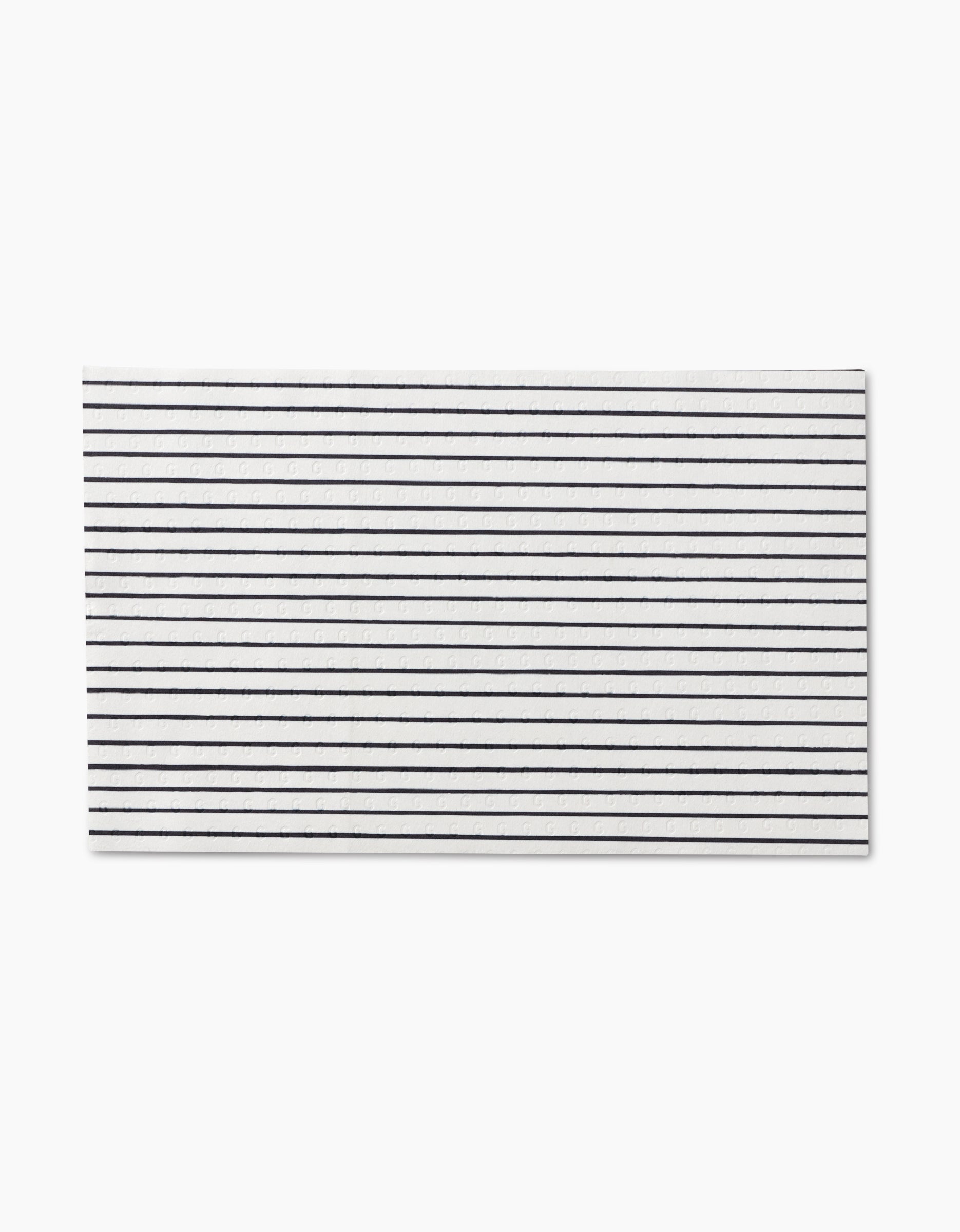 The GEOMETRY Lines, Dots and Dashes napkin is rectangular, white, features thin black horizontal stripes, and is crafted from eco-friendly post-consumer recycled materials. Not paper towels.