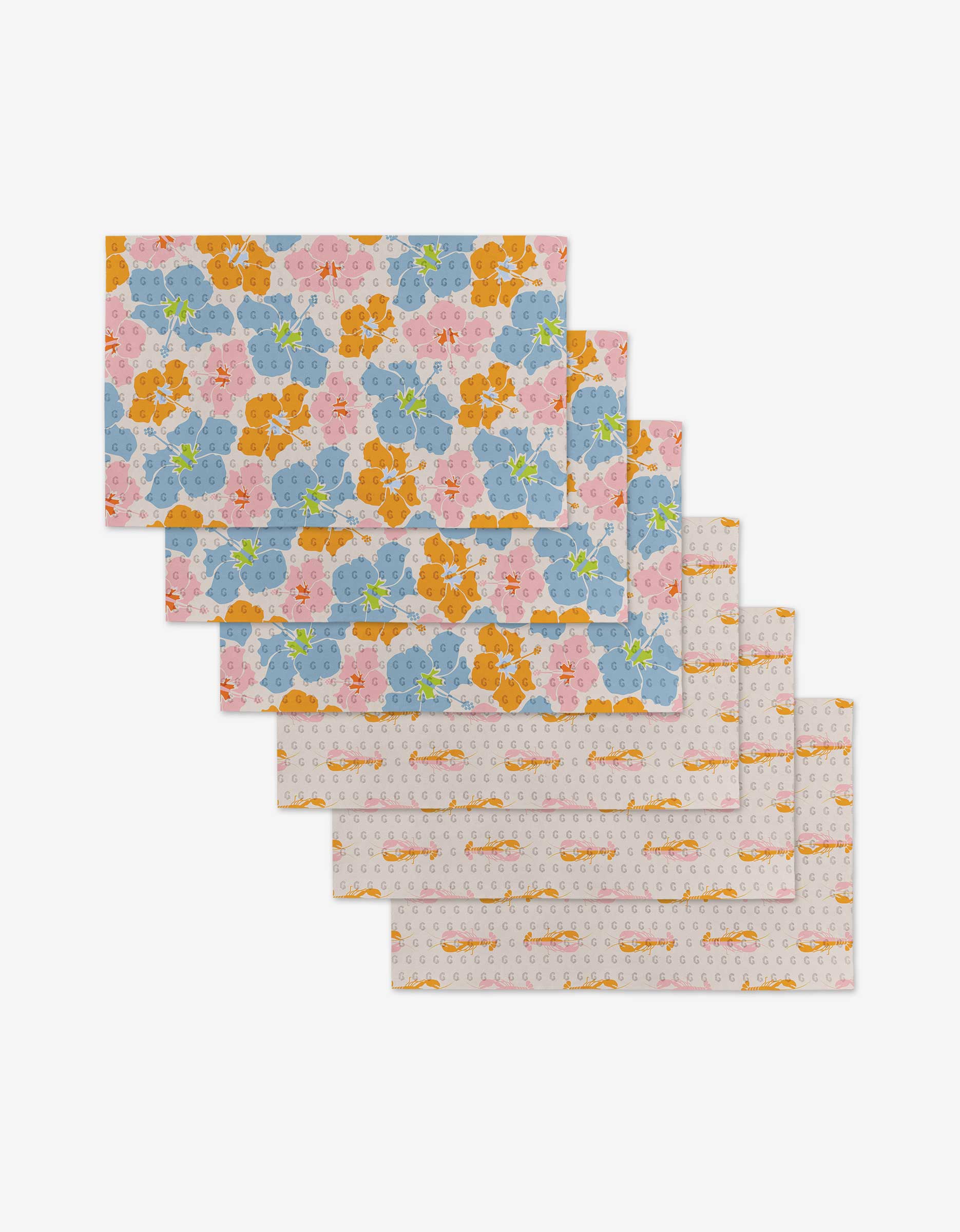 The GEOMETRY Lobster Love set includes six rectangular placemats, eco-friendly and reusable—not paper towels—ideal for stylish, sustainable dining. Features a vibrant floral pattern with blue, pink, and orange blooms on white.