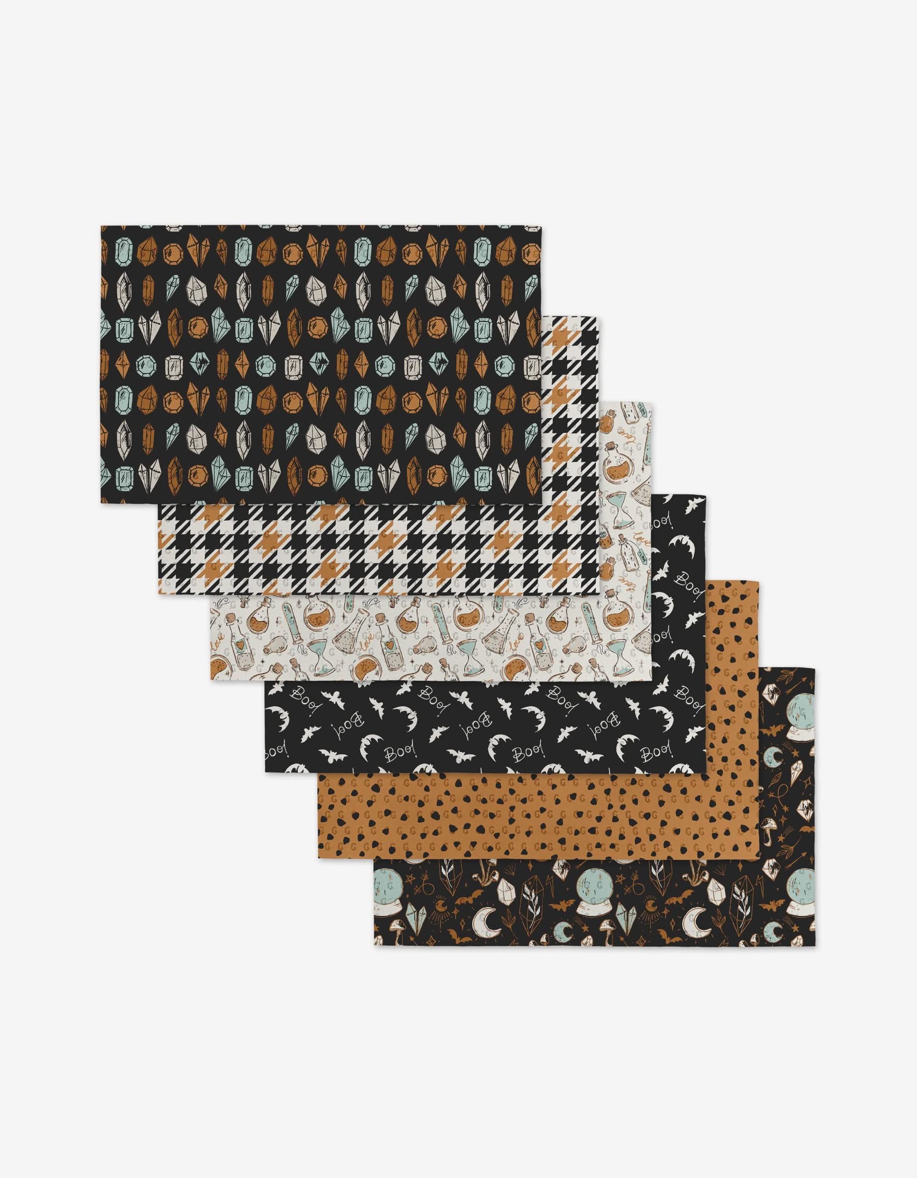 Six rectangular Love Potions fabric pieces by Hufton Studio, featuring autumn and Halloween-themed patterns—leaves, plaid, pumpkins, black cats, moons, and ghosts—as a reusable décor alternative.