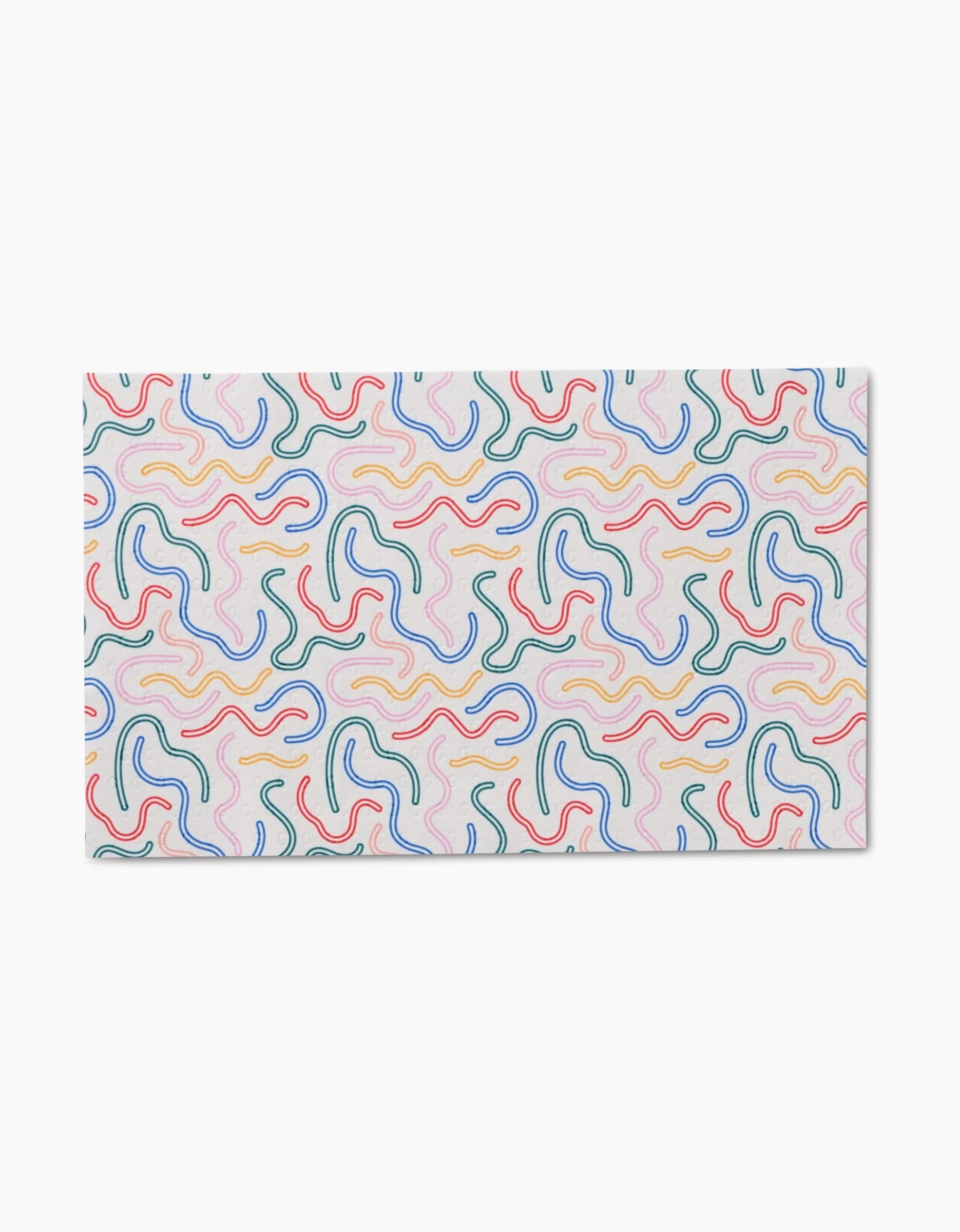 The Magic Wand by Happy Hemera is a rectangular mat with a white background and a vibrant abstract pattern of wavy lines in red, blue, green, yellow, and pink—crafted from recycled materials for eco-friendly appeal.