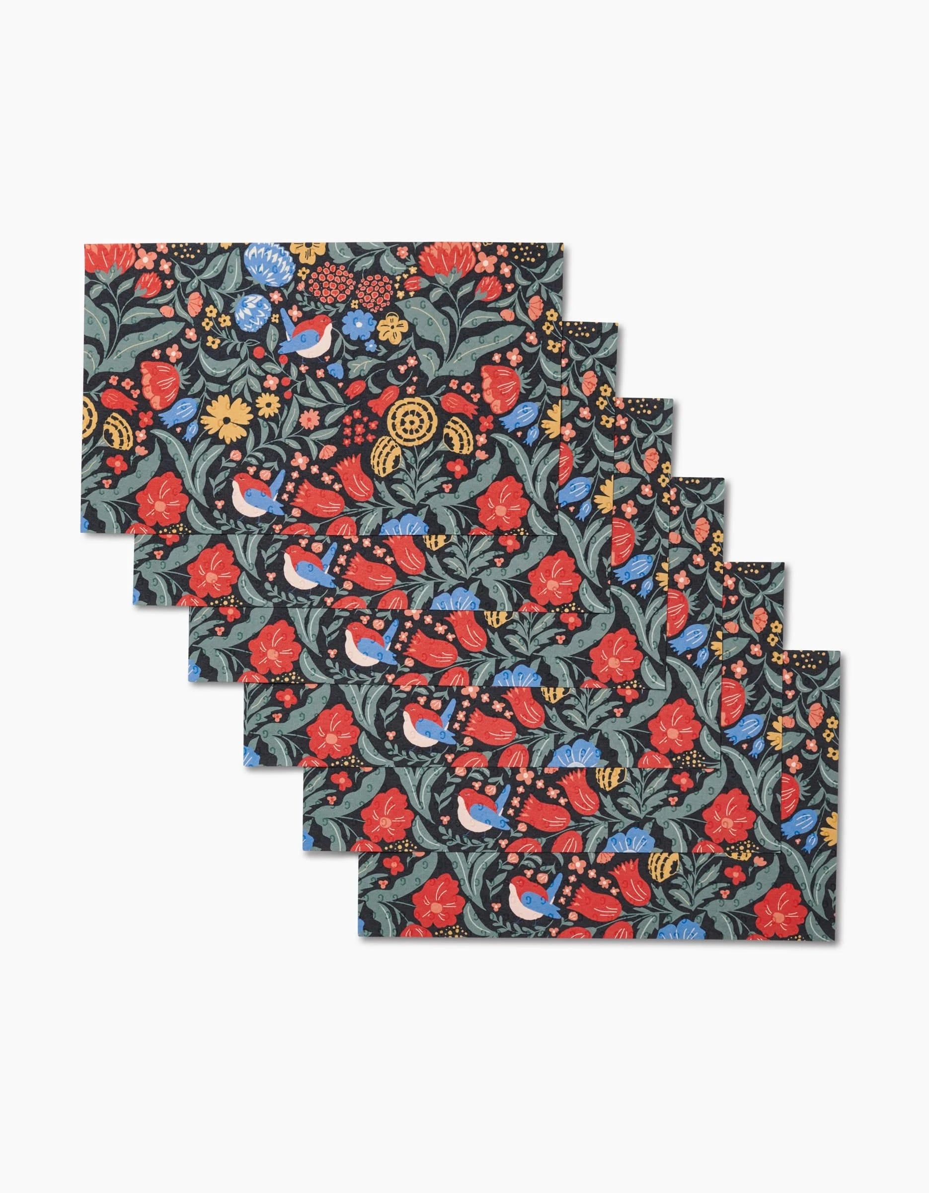 Six overlapping Marsh Wren Not Paper Towels by Danelys Sidron feature a floral and bird pattern—red, yellow, and orange flowers, green leaves, and blue birds on dark—an eco-friendly option for your table.