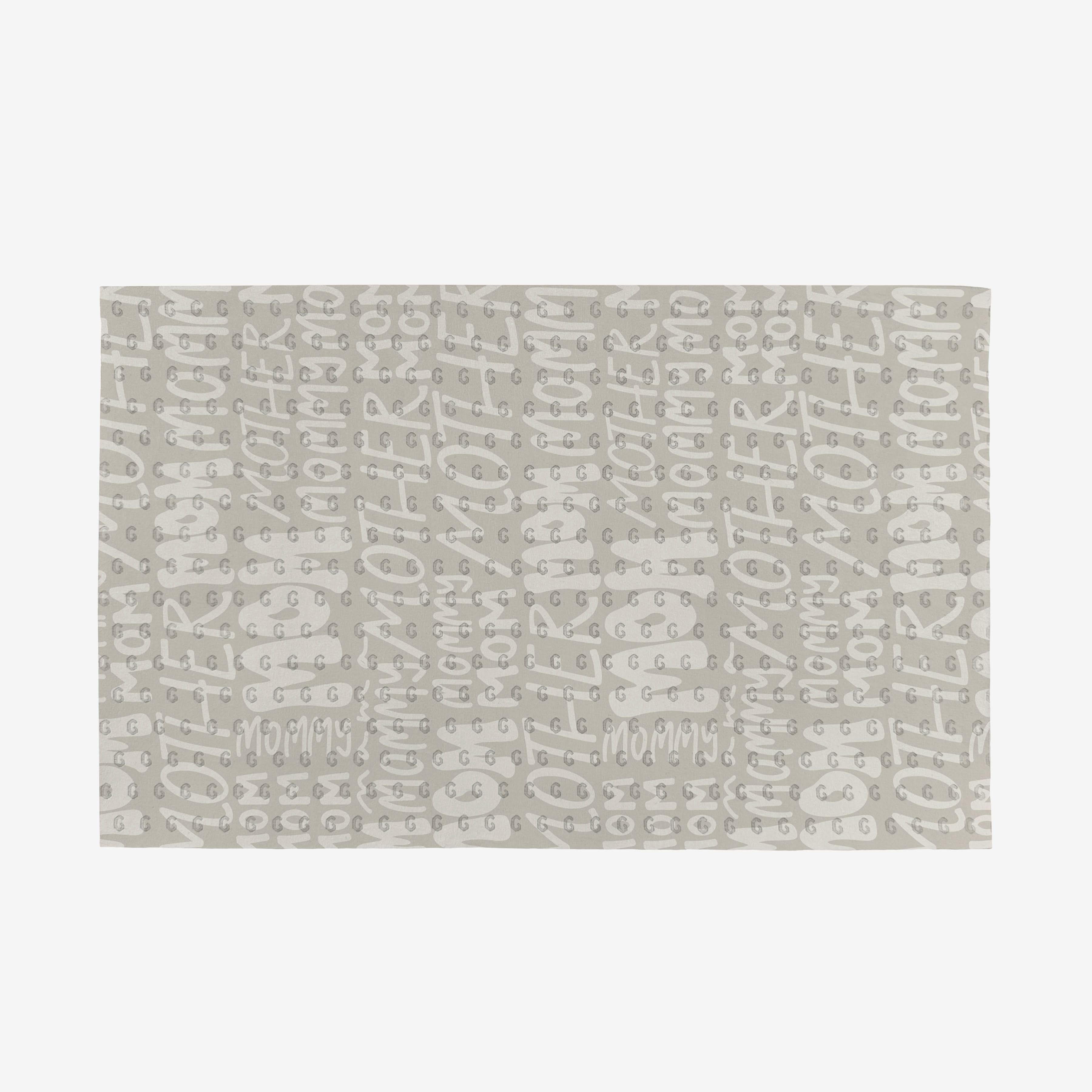 The GEOMETRY Mom mat features a repeating handwritten mommy pattern in light gray on white, made from eco-friendly materials—a stylish, planet-friendly choice.