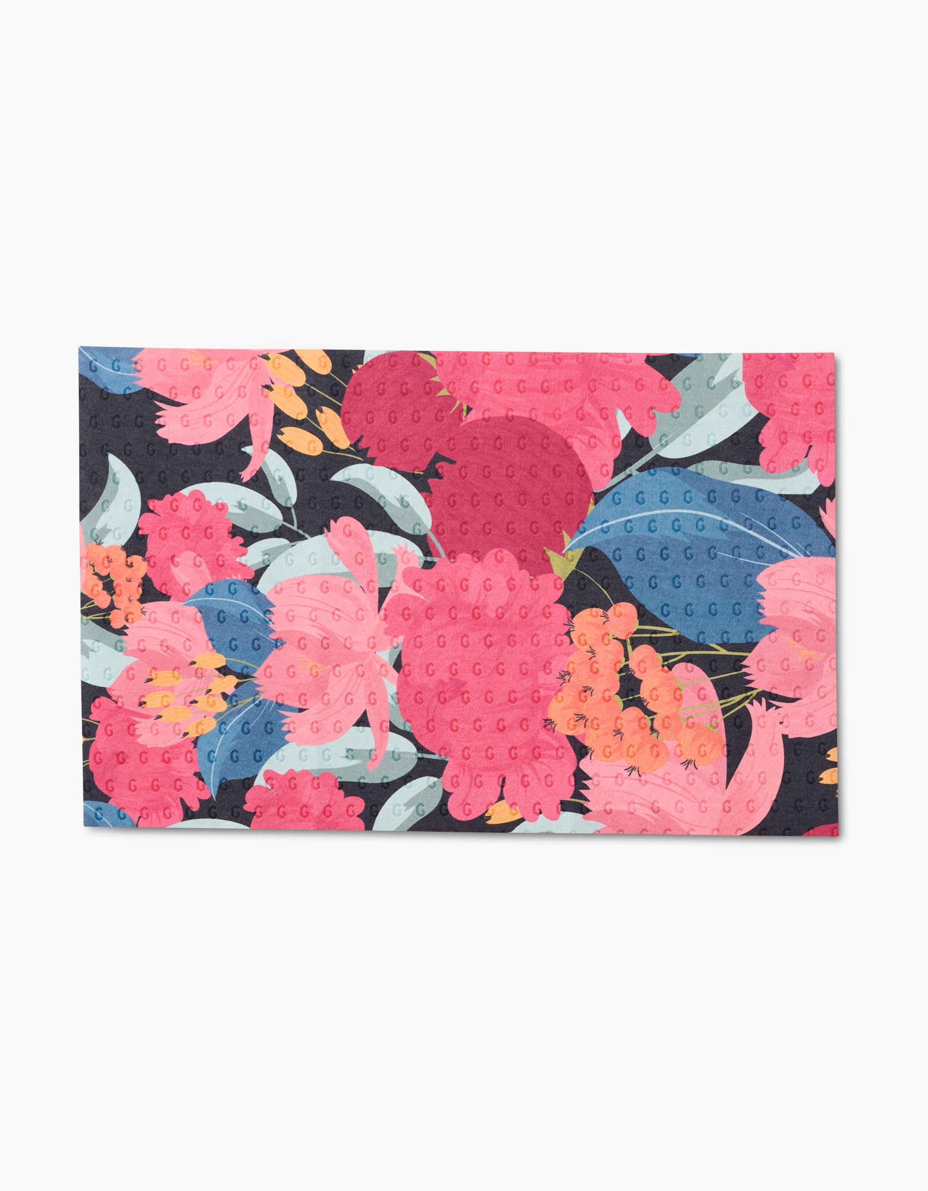 The GEOMETRY My Garden mat is a reusable, eco-friendly rectangular mat with large pink, red, and blue floral patterns on a dark background. It features a textured, grippy surface with raised dots—no paper towels needed!.