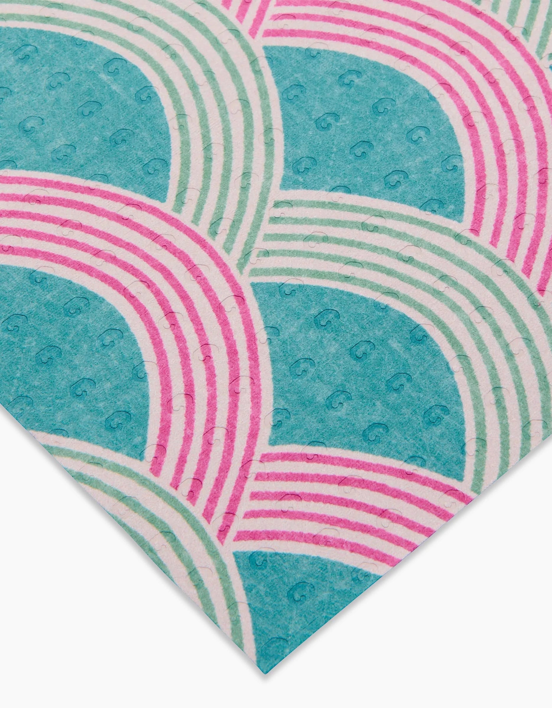 A close-up of Nalin by Amy MacCready: eco-friendly, patterned paper with overlapping teal semicircles, swirl accents, and pink curved stripes. A geometric, retro-inspired design—stylish sustainability beyond paper towels.