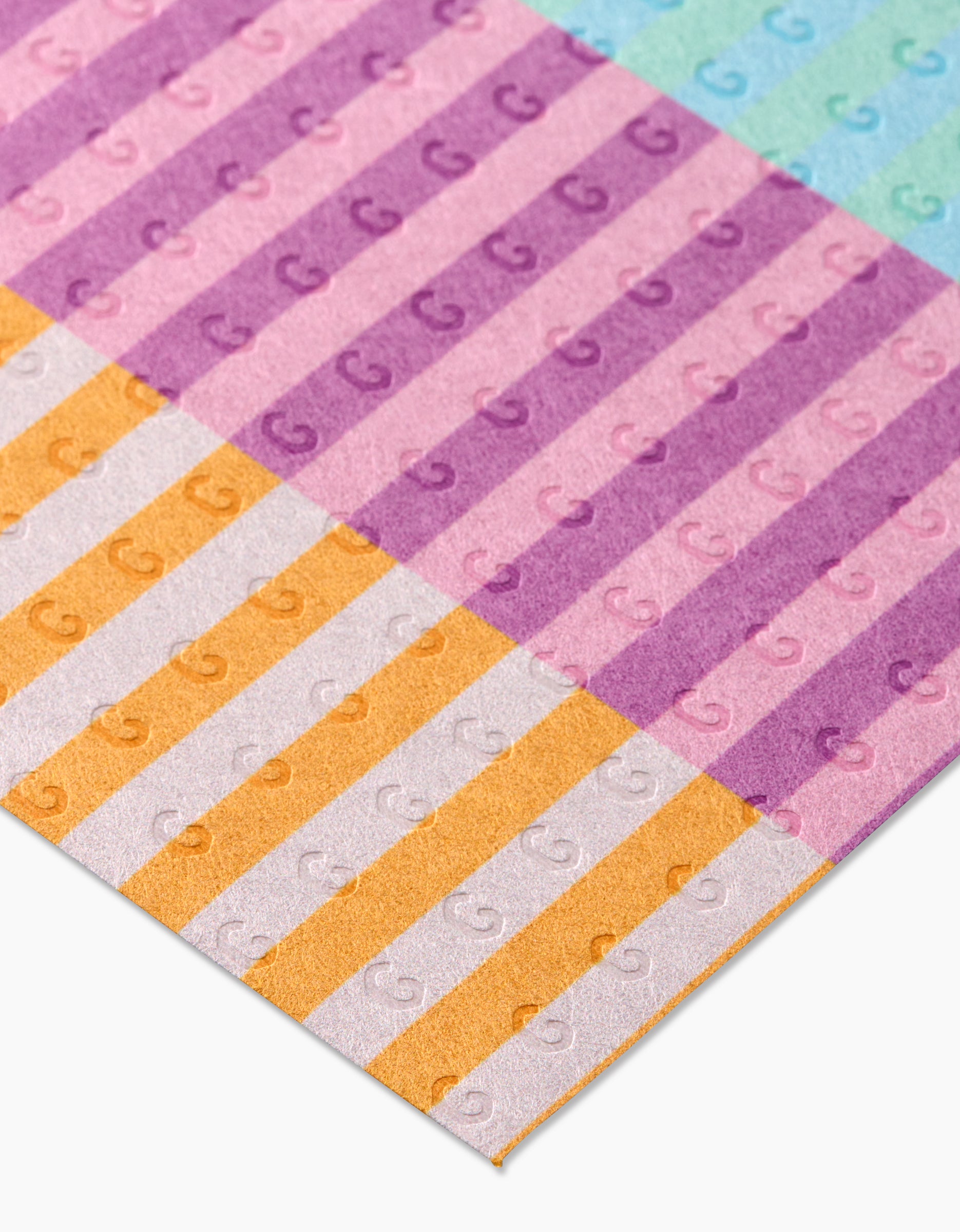 Reusable Neon Nights by GEOMETRY features pastel-striped paper sheets in pink, purple, orange, and blue with an embossed G pattern—an eco-friendly Not Paper Towels alternative.