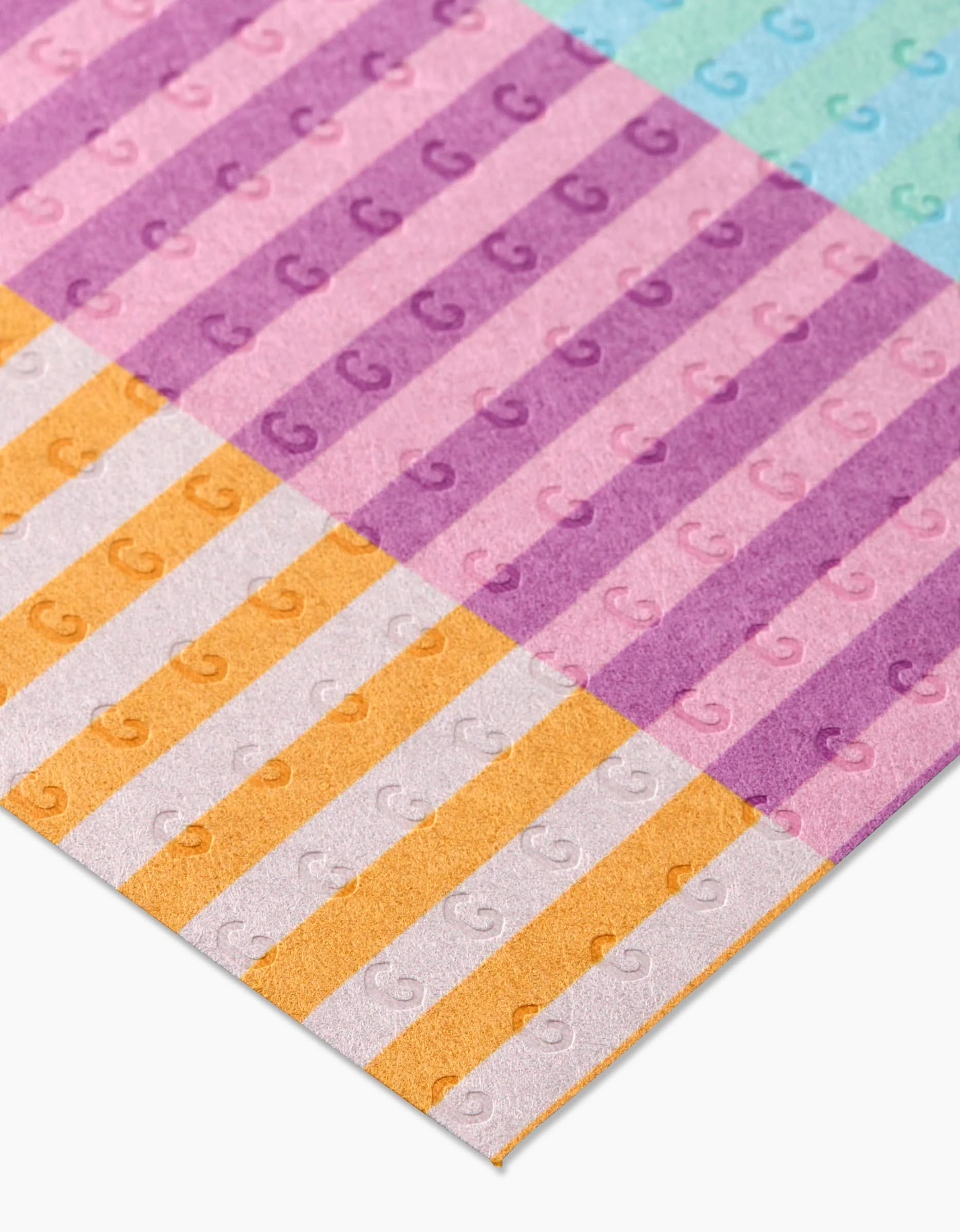 Reusable Neon Nights by GEOMETRY features pastel-striped paper sheets in pink, purple, orange, and blue with an embossed G pattern—an eco-friendly Not Paper Towels alternative.