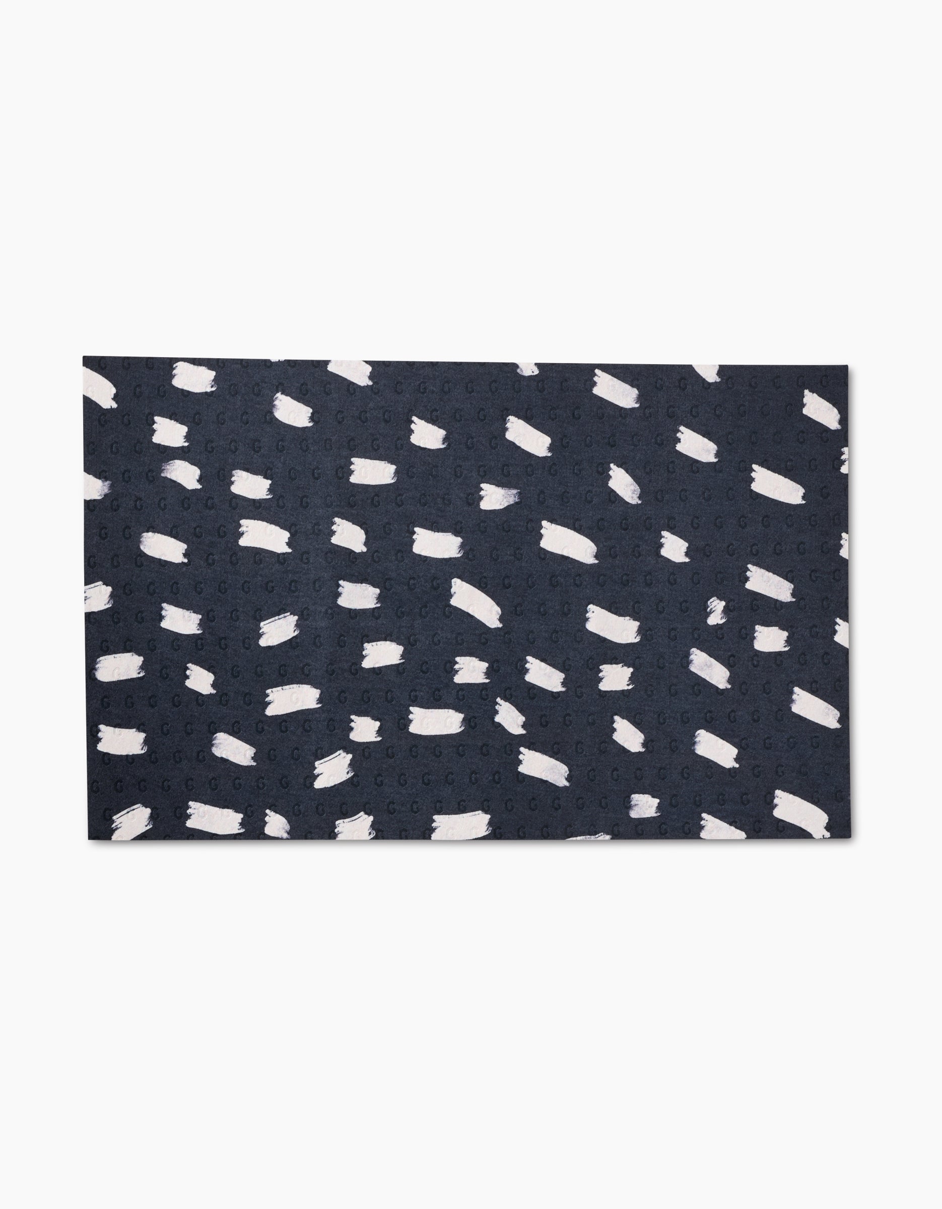 The GEOMETRY Pop Of Color rug features a rectangular dark blue design with abstract white brushstroke patterns, crafted from post-consumer recycled materials for an eco-friendly alternative to standard rugs.