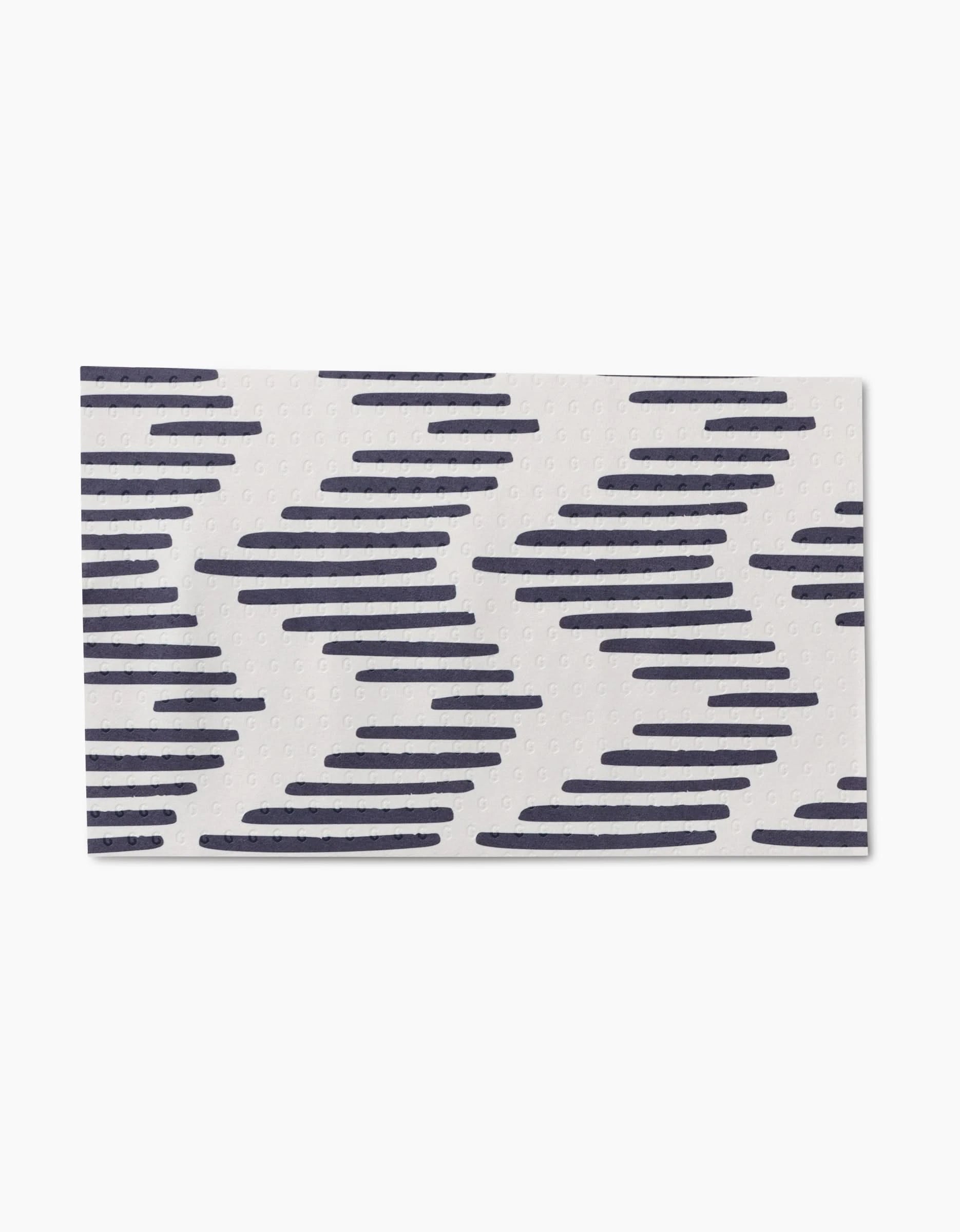 Pop Of Color by GEOMETRY is a rectangular white mat with diagonal navy blue zigzag lines, made from post-consumer recycled materials for an eco-friendly touch.