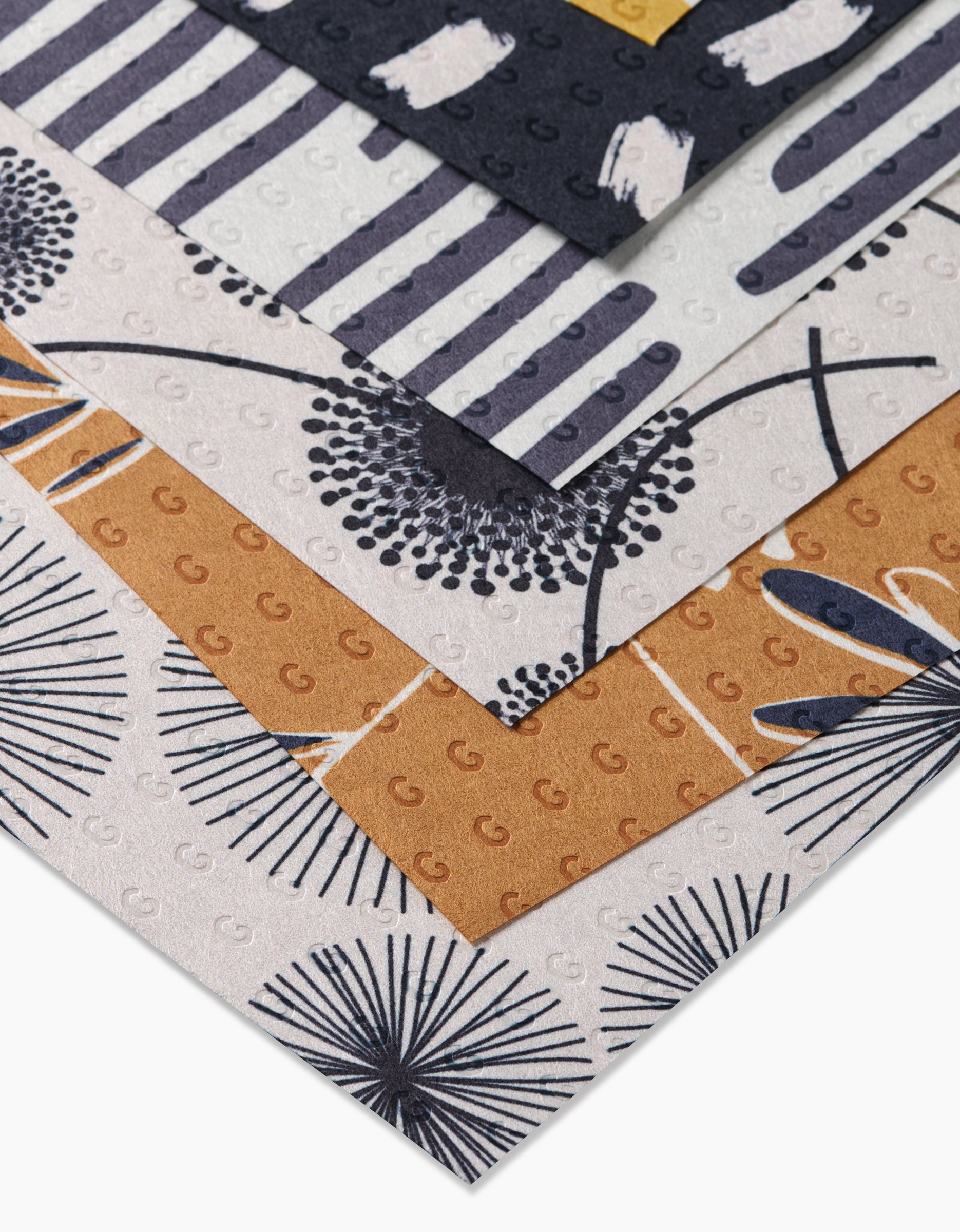A close-up of GEOMETRY’s Pop Of Color Not Paper Towels, featuring bold patterns in black, white, mustard yellow, and grey—an eco-friendly alternative to paper towels.